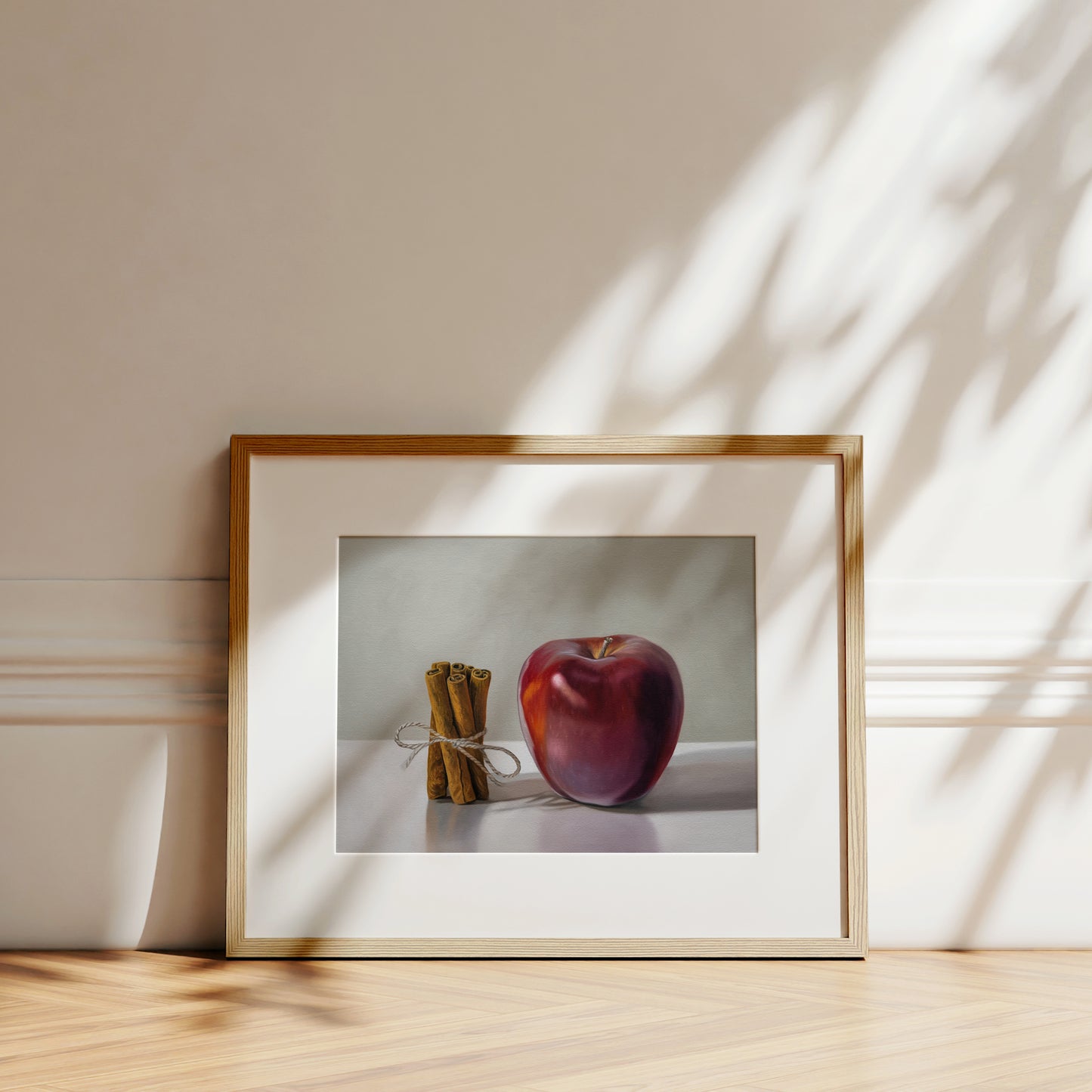 This artwork features a bundle of cinnamon sticks standing next to a red delicious apple with a neutral, minimalistic backdrop.