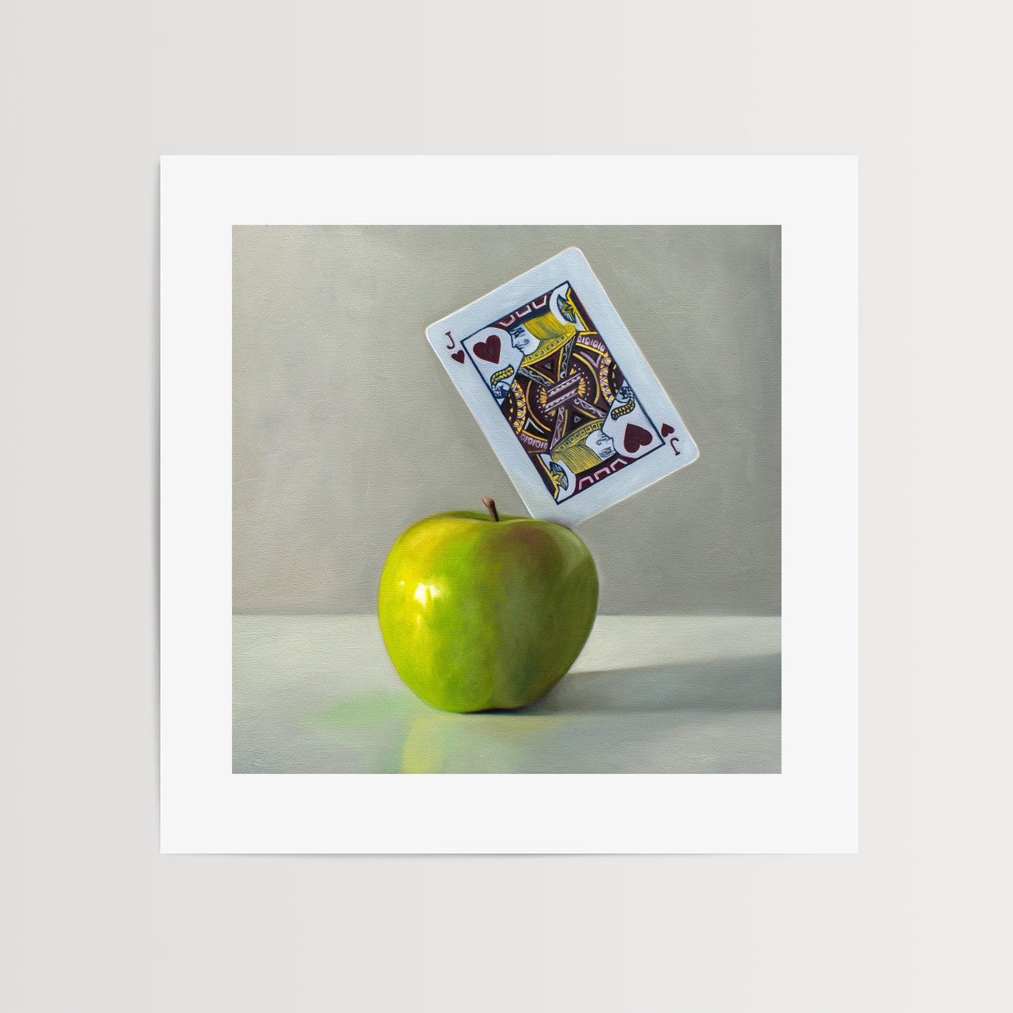 This artwork features a pun on the word ‘Applejack’. A Jack of Hearts playing card is embedded in the upper right corner of a bright green granny smith apple.