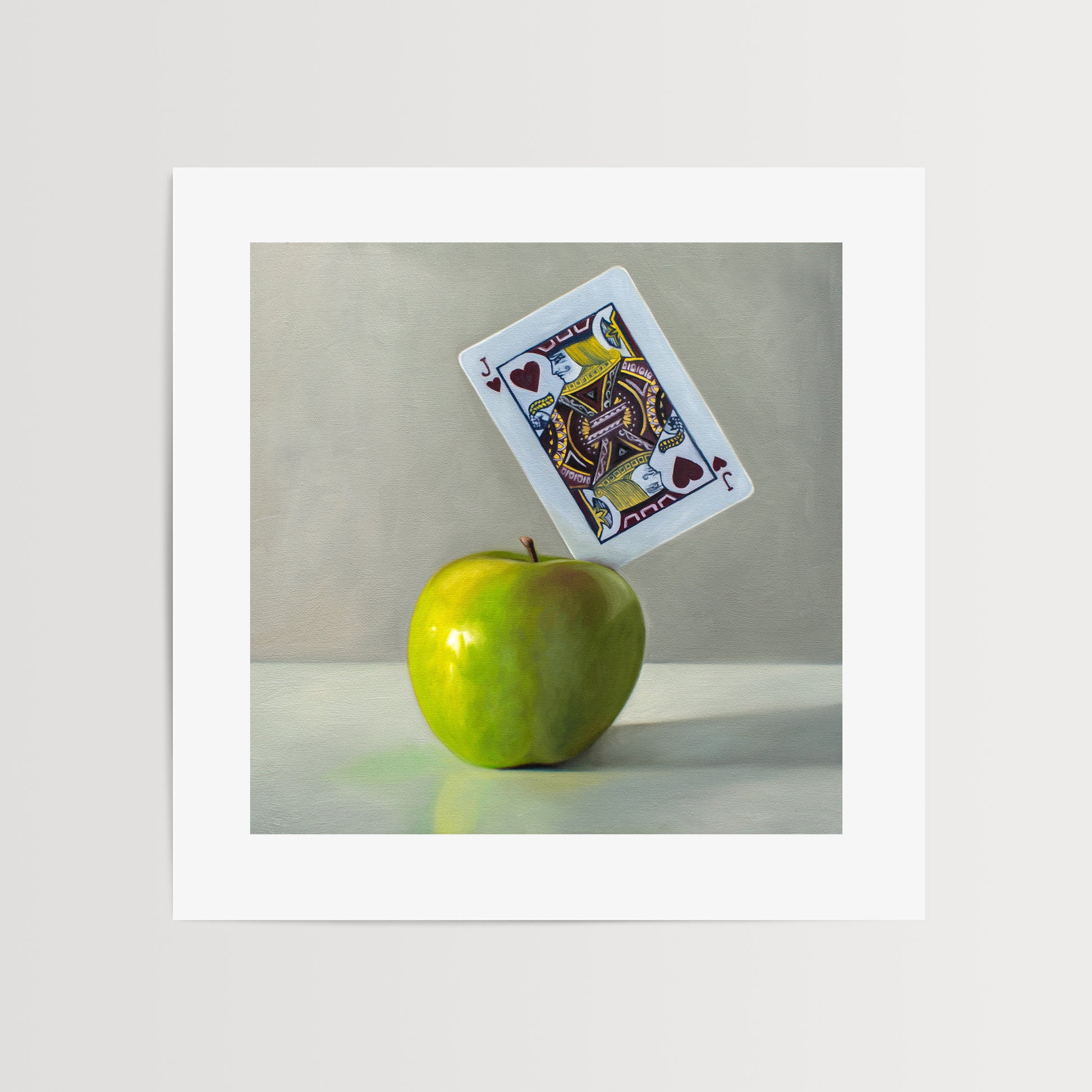 This artwork features a pun on the word ‘Applejack’. A Jack of Hearts playing card is embedded in the upper right corner of a bright green granny smith apple.