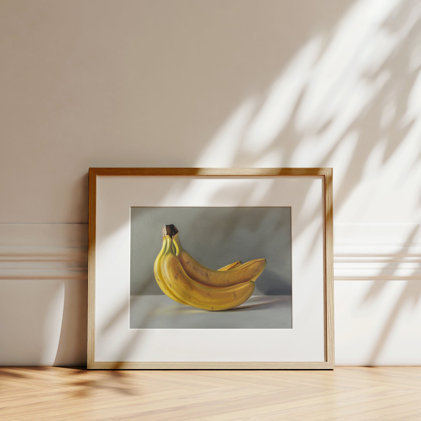 This artwork features a bunch of bananas resting on a light surface.