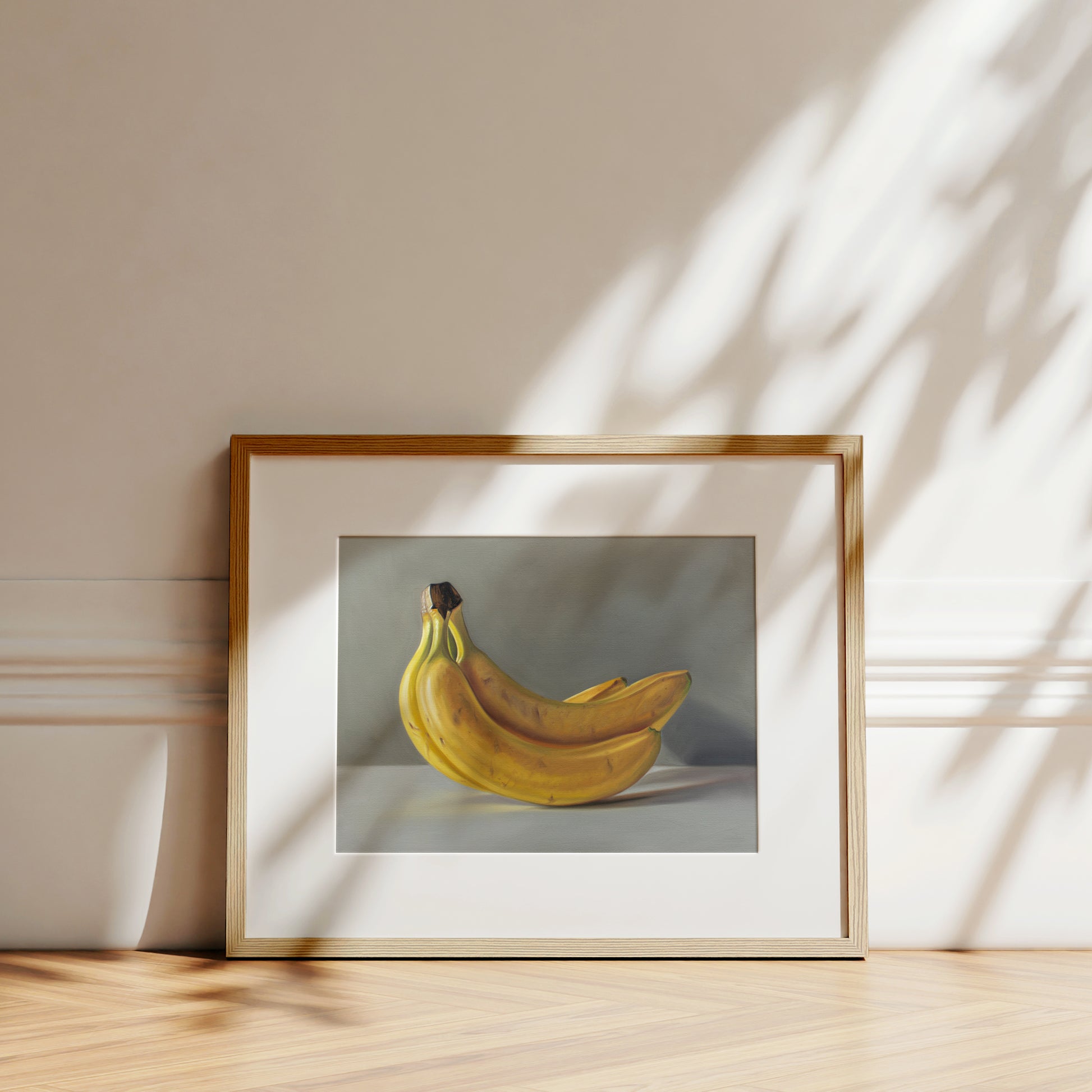 This artwork features a bunch of bananas resting on a light surface.