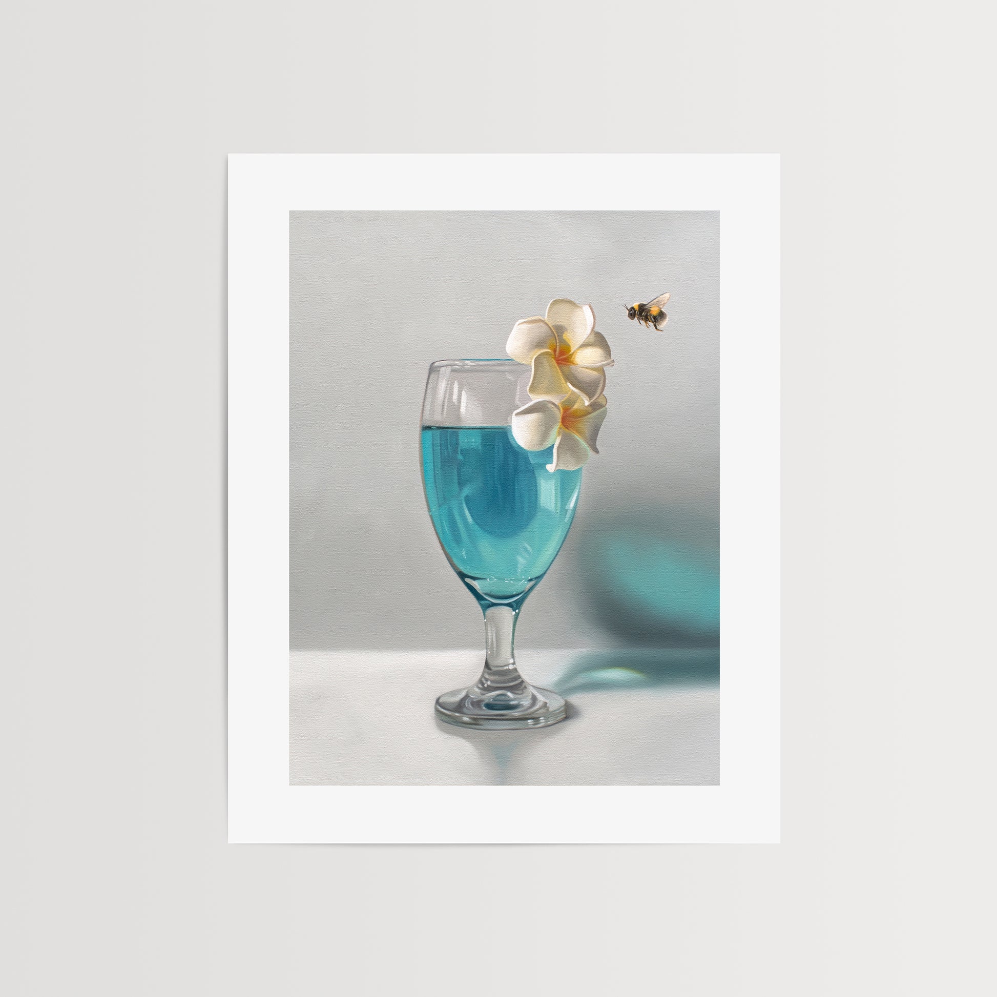 This artwork features a curious bumble bee inspecting a pair of plumeria blossoms that rest upon a tropical blue lagoon cocktail.