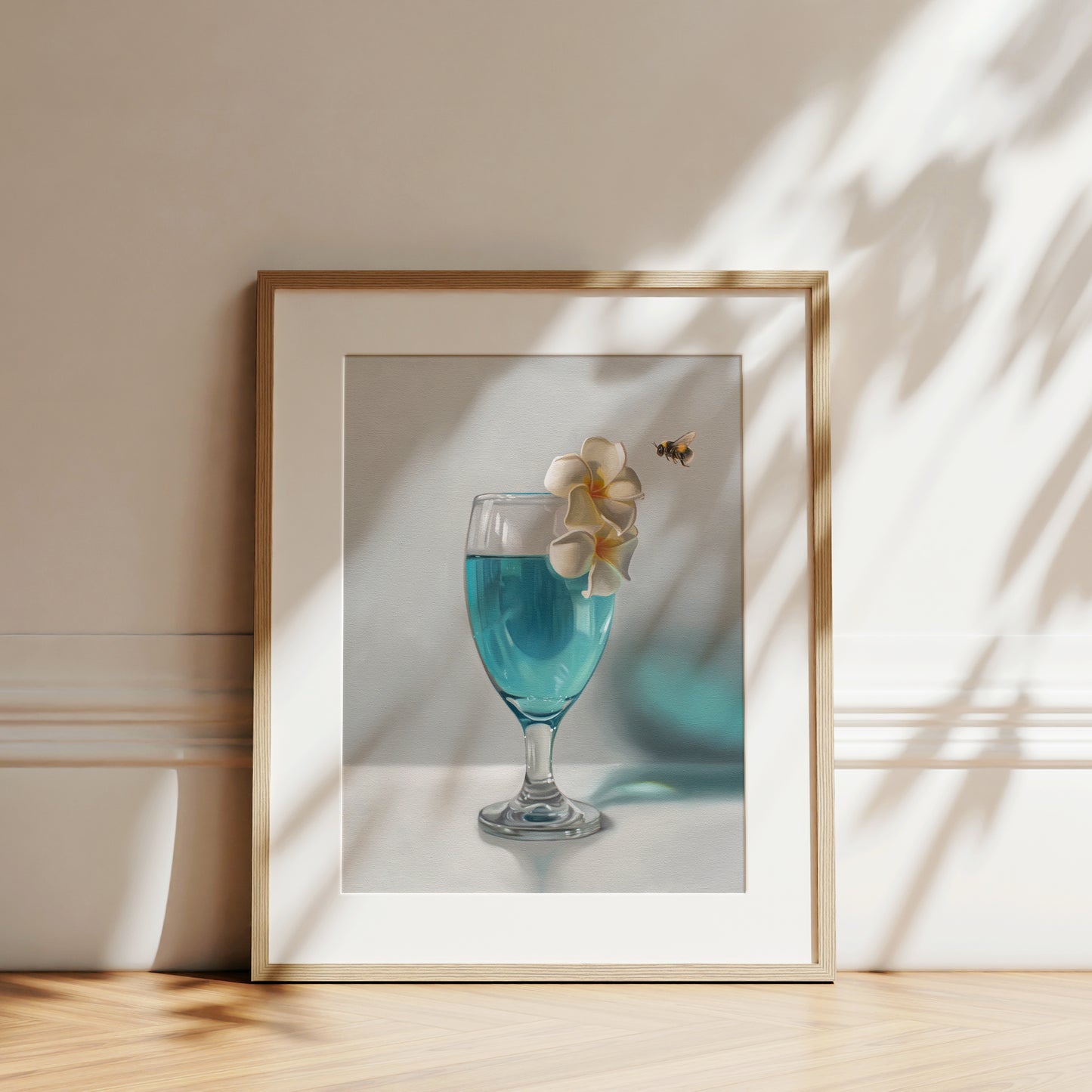 This artwork features a curious bumble bee inspecting a pair of plumeria blossoms that rest upon a tropical blue lagoon cocktail.