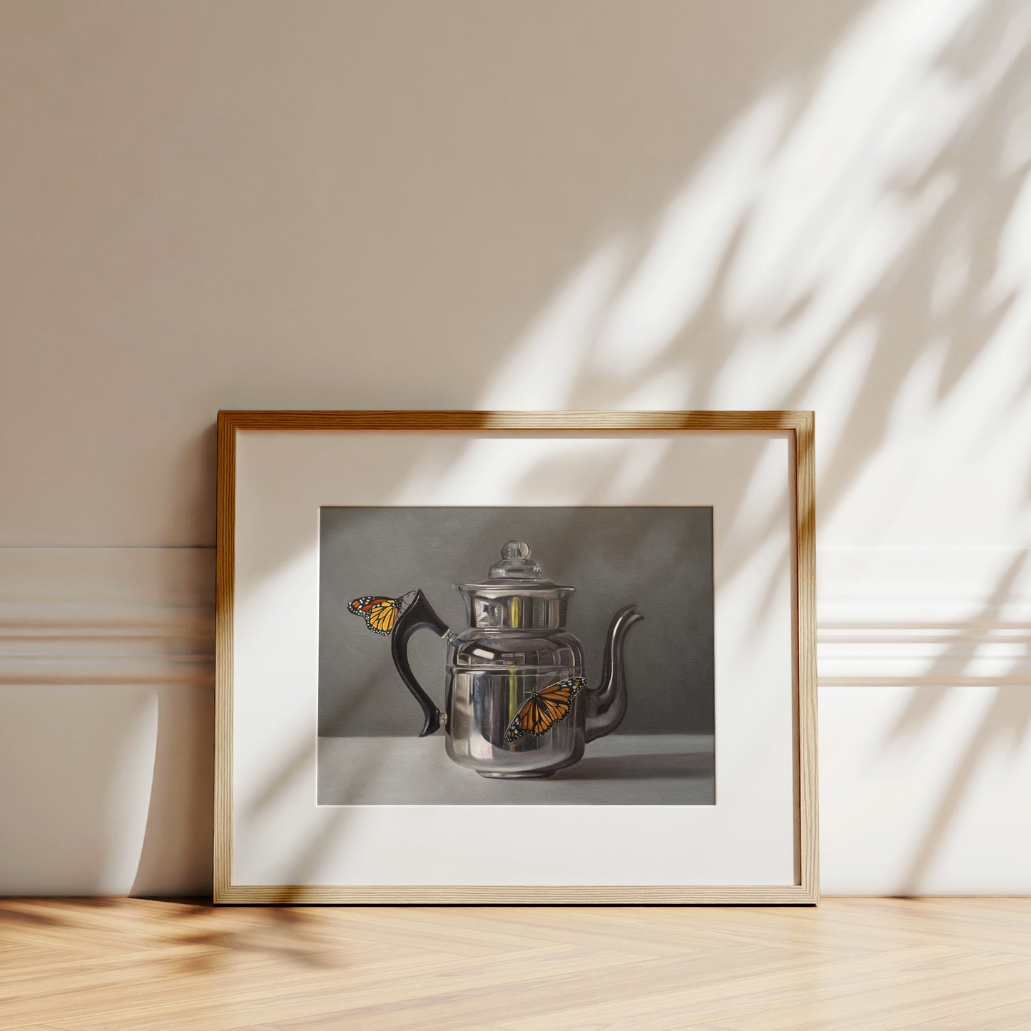 This artwork features a pair of monarch butterflies perched on a vintage reflective kettle.
