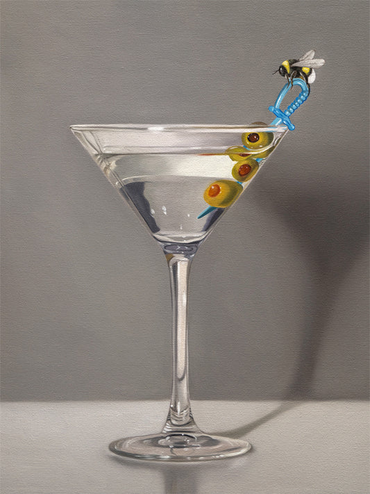 This artwork features a martini with a bumble bee perched on a blue plastic cocktail sword with a trio of green olives and a neutral, minimalistic backdrop.
