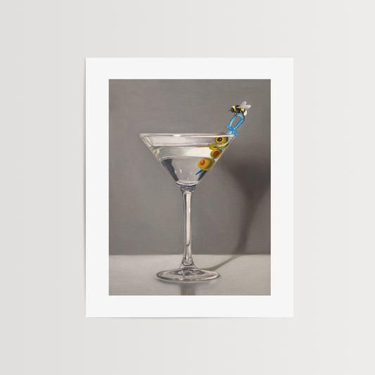This artwork features a martini with a bumble bee perched on a blue plastic cocktail sword with a trio of green olives and a neutral, minimalistic backdrop.
