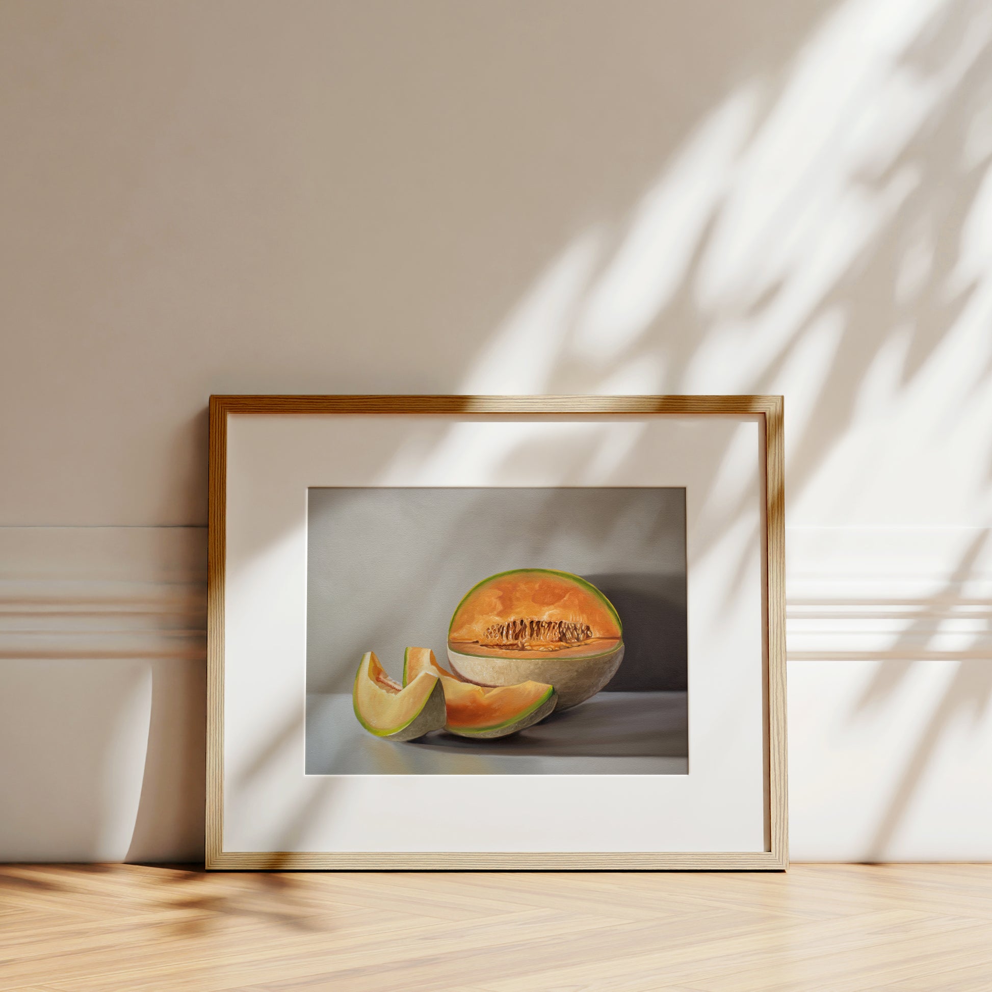 This artwork features a freshly sliced cantaloupe resting on a light grey surface with some nice dramatic lighting.