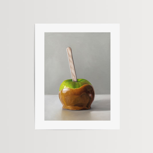This artwork features a freshly dipped caramel apple resting on a light, reflective surface.