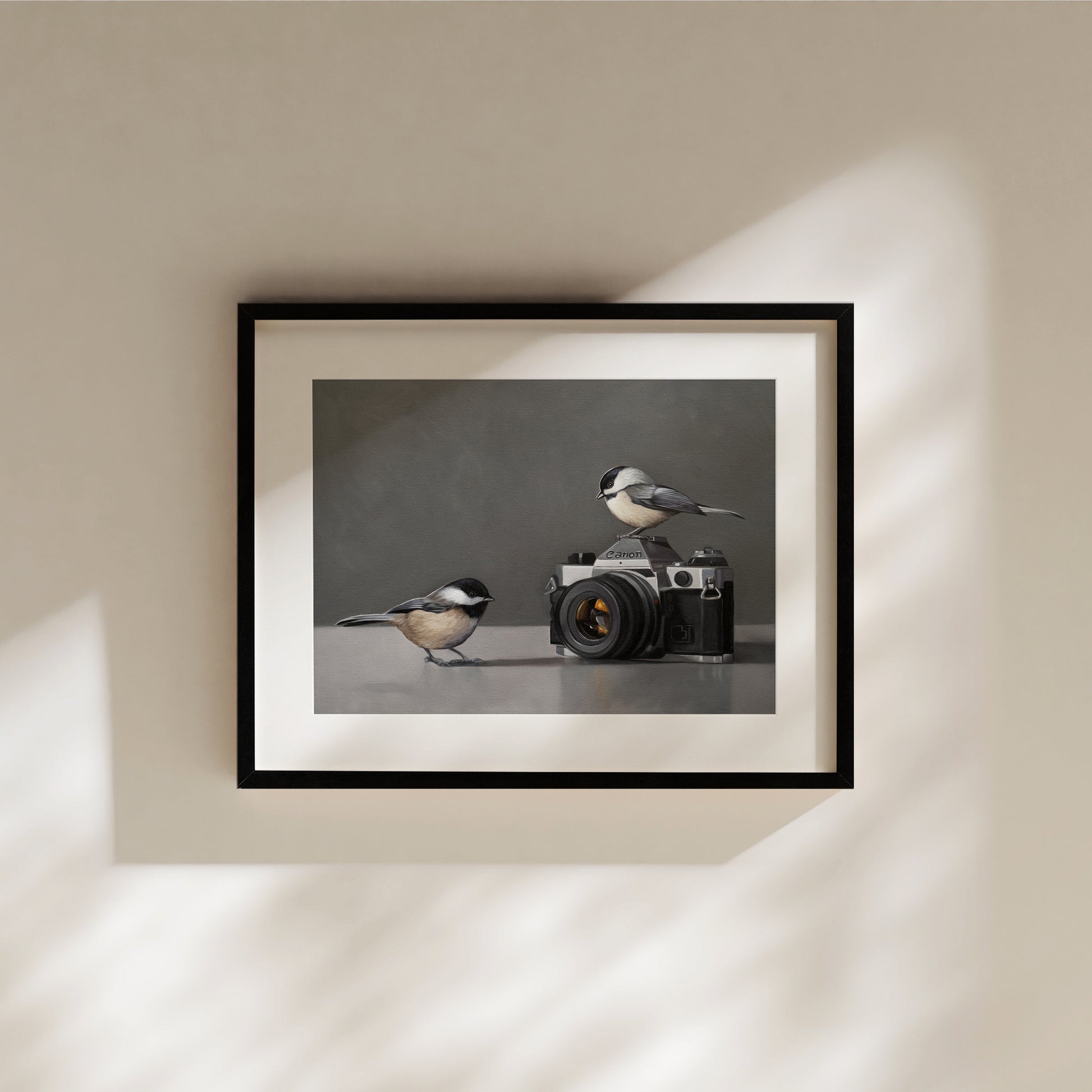 This artwork features a pair of inquisitive Chickadees investigating a vintage 35mm Canon Camera.