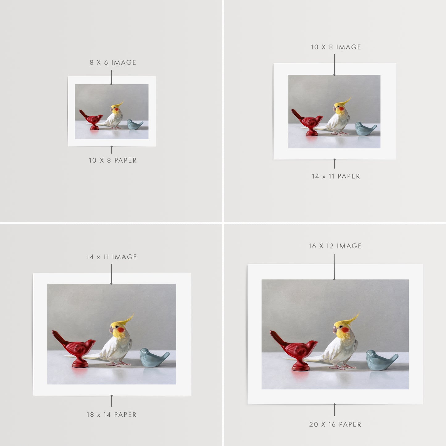 This artwork features a white cockatiel standing in between a red and blue bird figurine on a light, reflective surface with dramatic lighting.