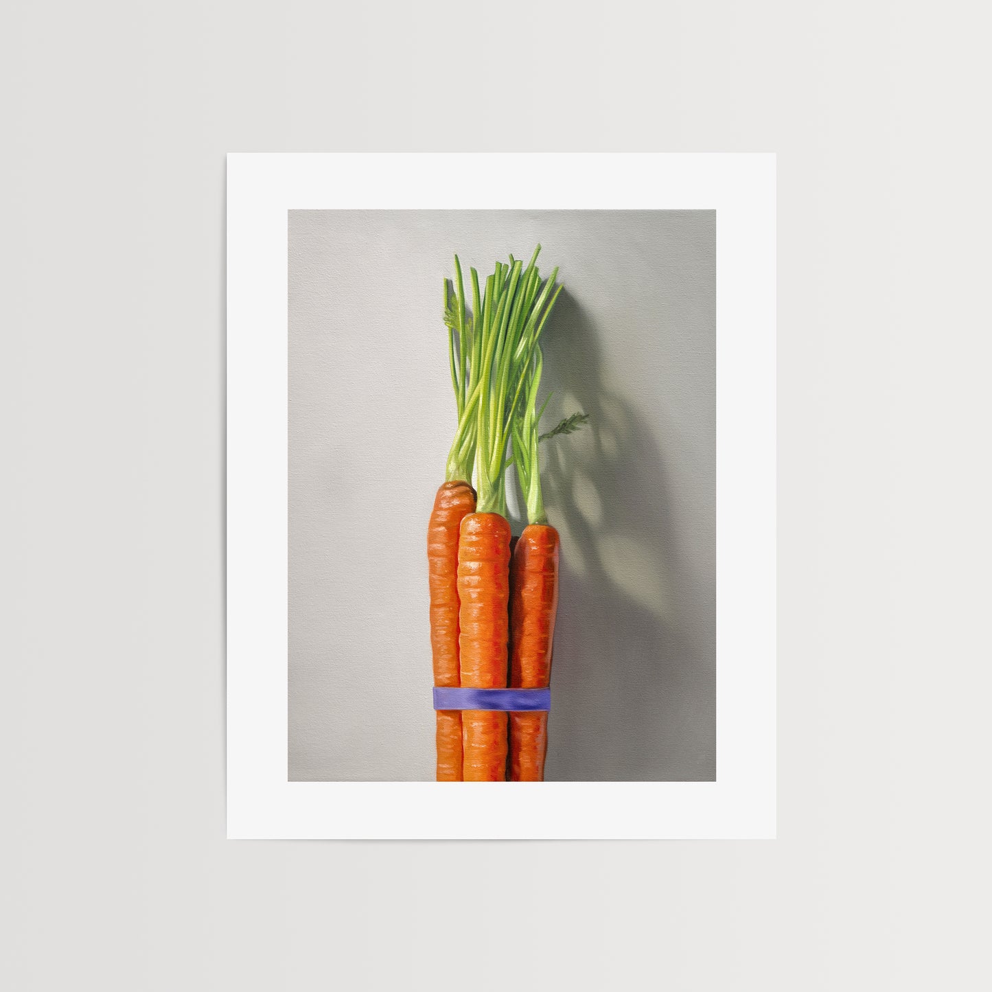 This artwork features a bundle of carrots resting on a neutral grey surface with dramatic side lighting creating interesting cast shadows.