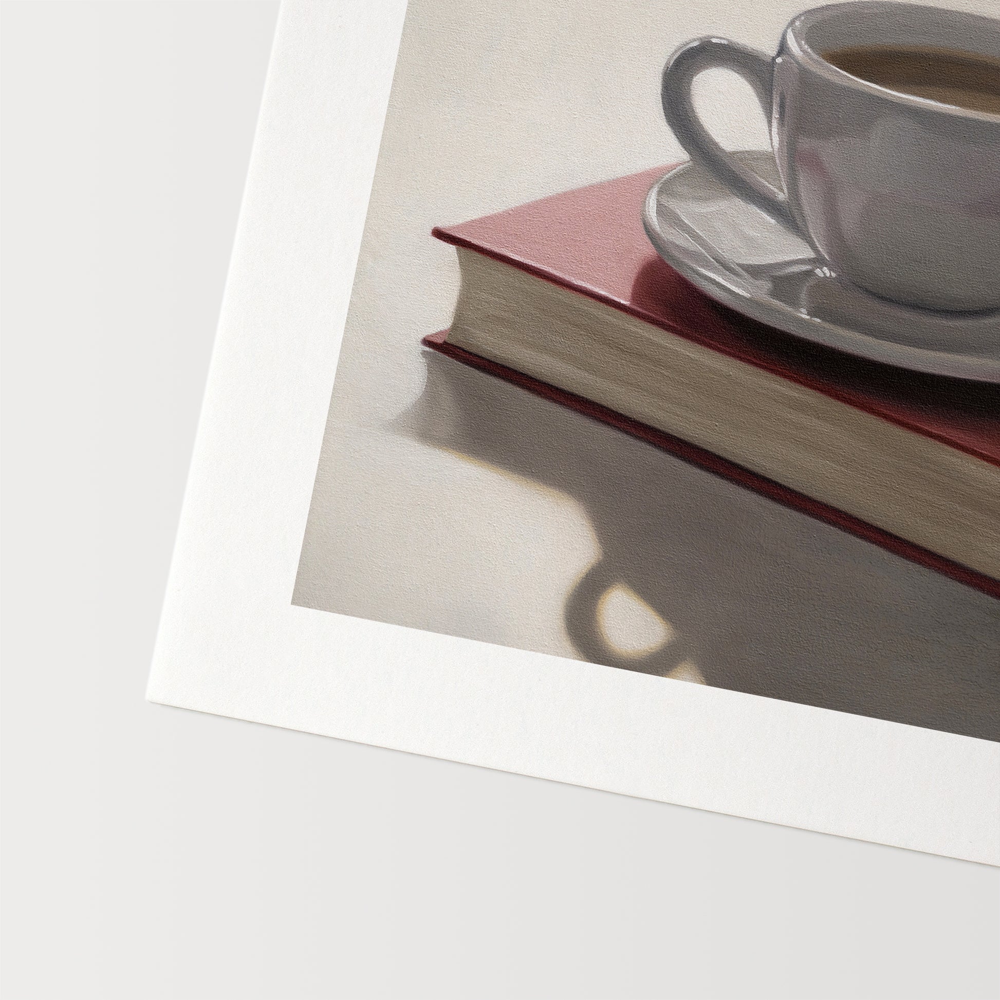 This artwork features a backlit coffee cup and saucer resting on top of a red book.