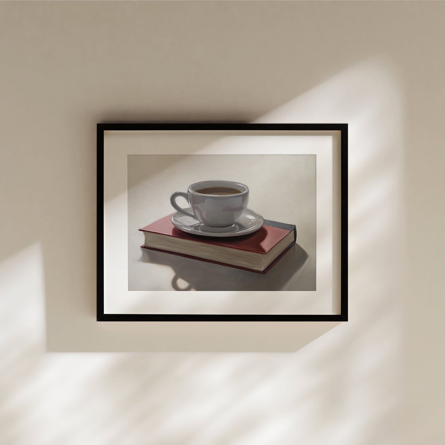 This artwork features a backlit coffee cup and saucer resting on top of a red book.