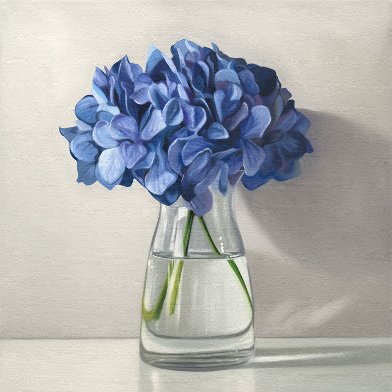 This artwork features a bouquet of blue hydrangeas in a glass vase with a light grey neutral background dramatic side-lighting.