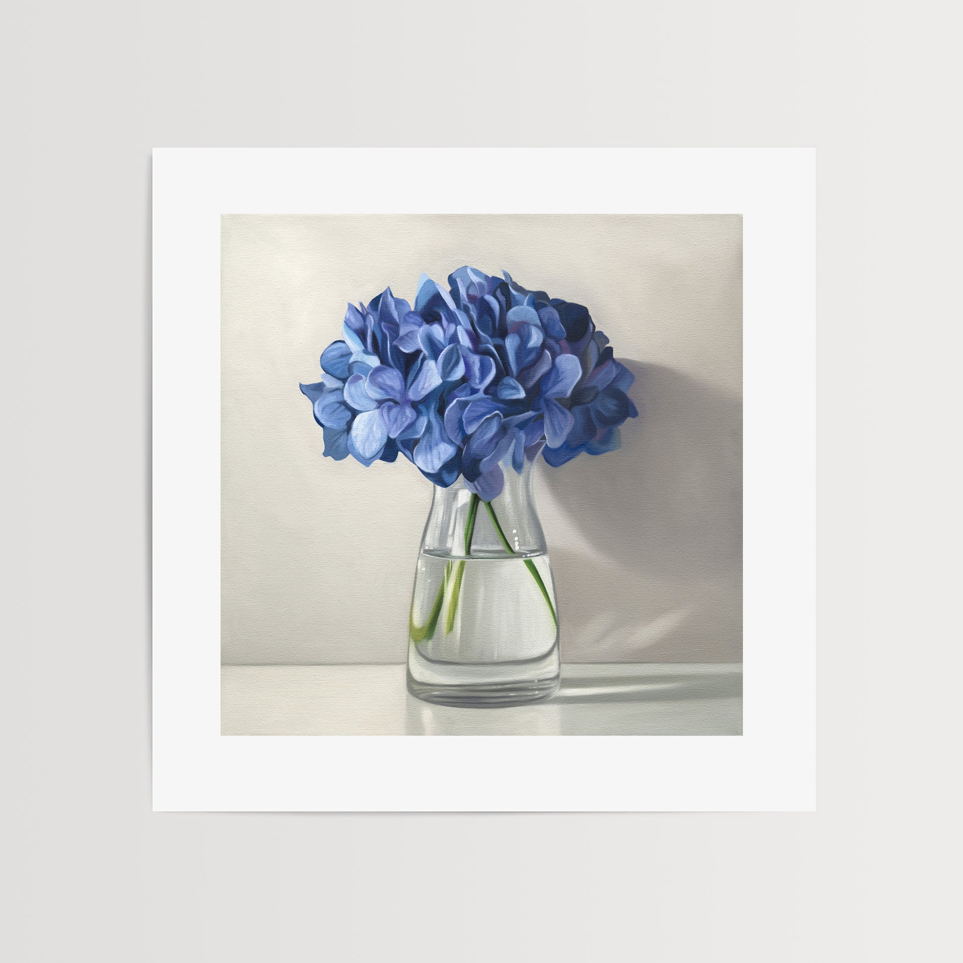This artwork features a bouquet of blue hydrangeas in a glass vase with a light grey neutral background dramatic side-lighting.