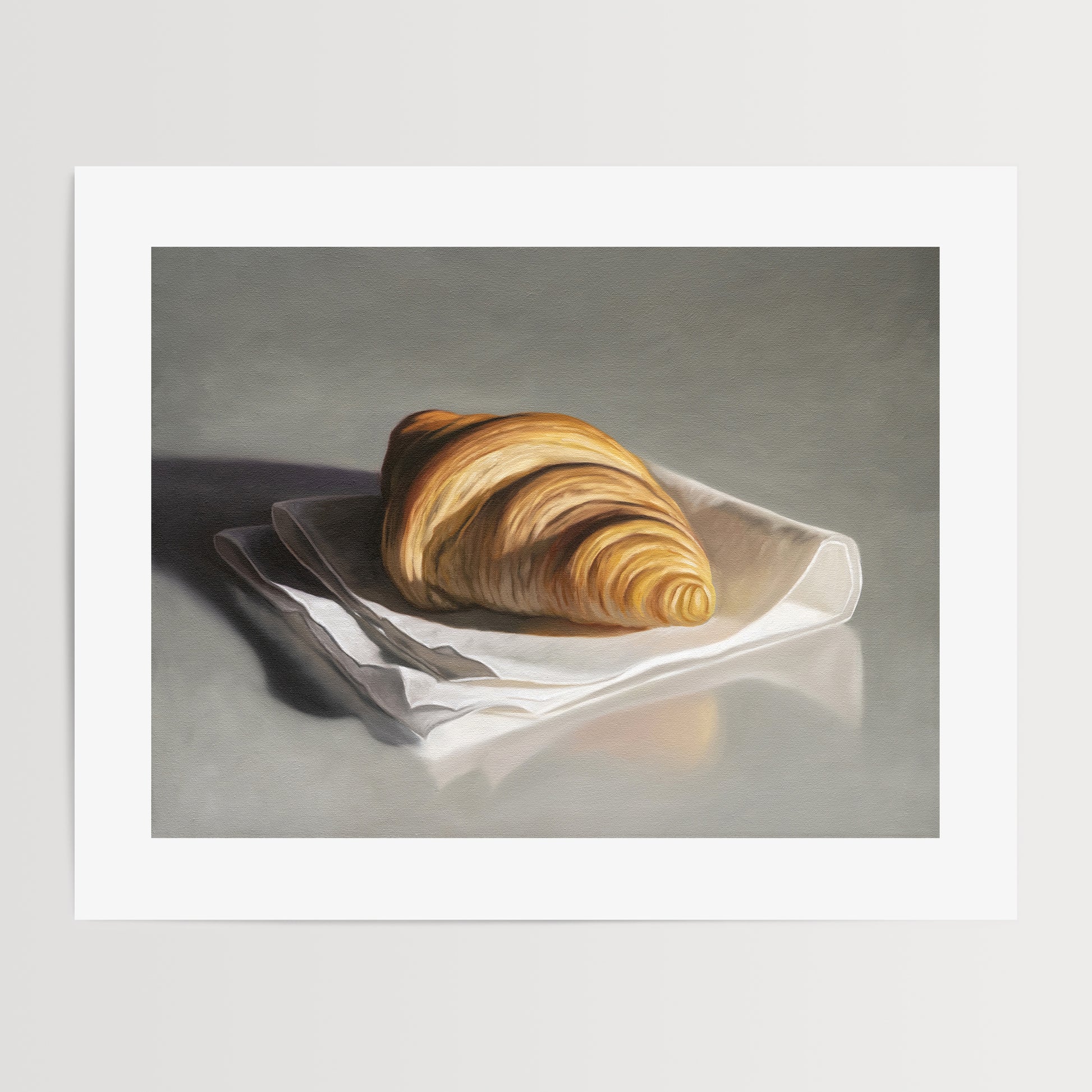 This artwork features a single freshly baked croissant resting on a napkin on a reflective surface.