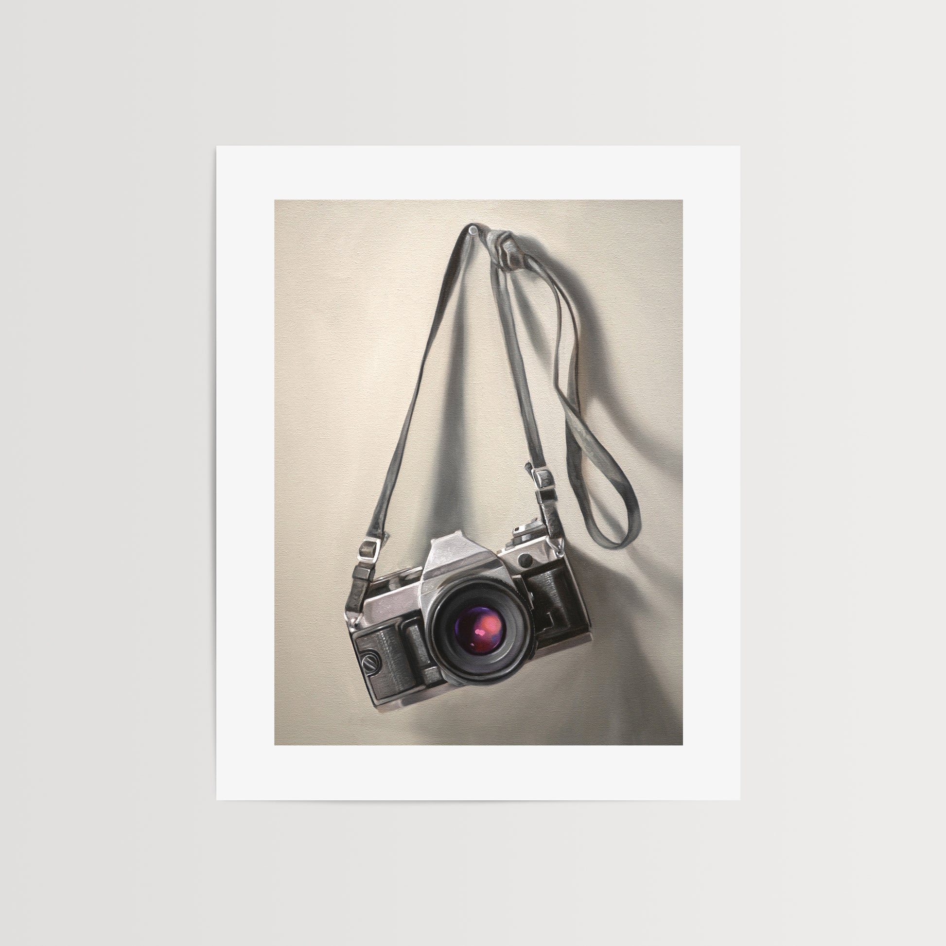 This artwork features a vintage 35mm camera hanging from its strap with some nice dramatic lighting.