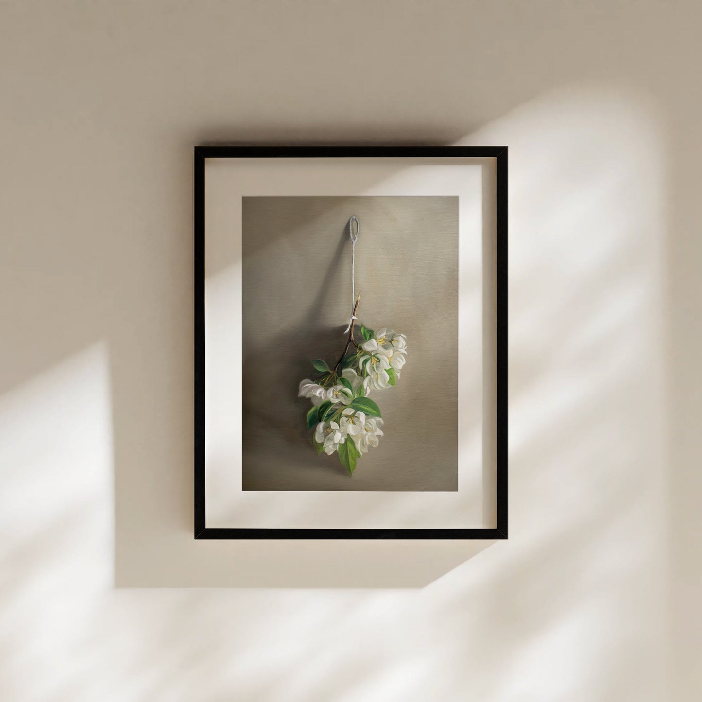 This artwork features a branch of crabapple blossoms hanging adjacent to a warm grey surface.