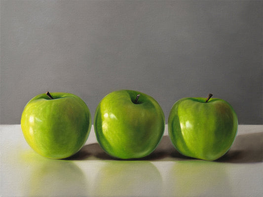 This artwork features a trio of bright green granny smith apples resting on a light, reflective surface with a neutral grey background.