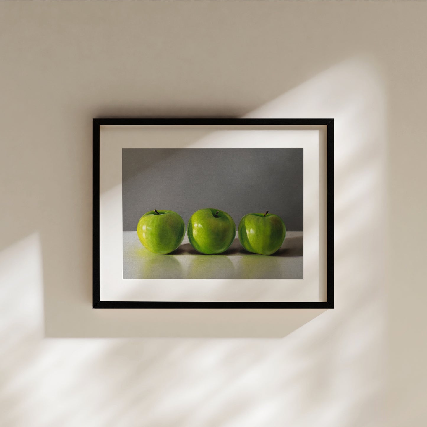 This artwork features a trio of bright green granny smith apples resting on a light, reflective surface with a neutral grey background.