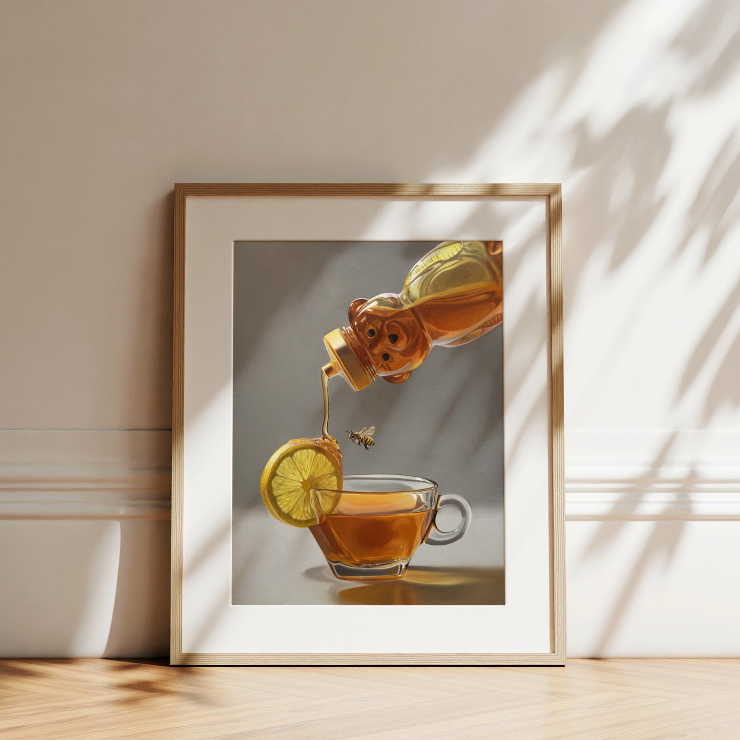 This artwork features a honey bee observing a backlit tipped honey bear bottle drizzling golden honey down onto a lemon slice that rests on the lip of a glass cup of tea.