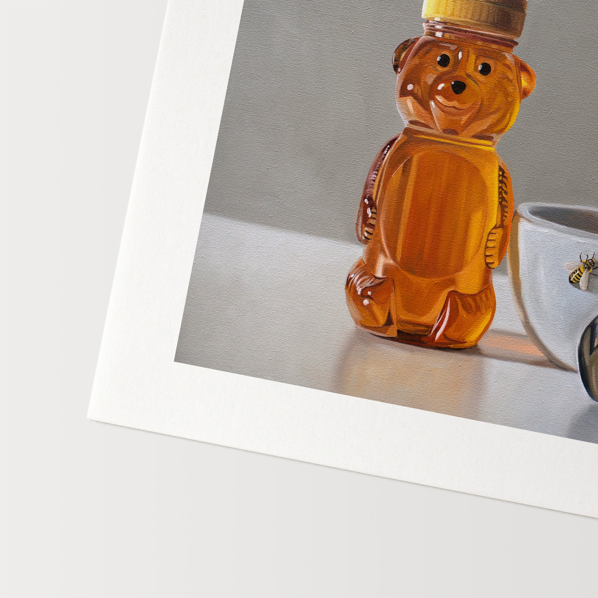 This artwork features a honey bear bottle, cup with spoon and two curious honey bees.