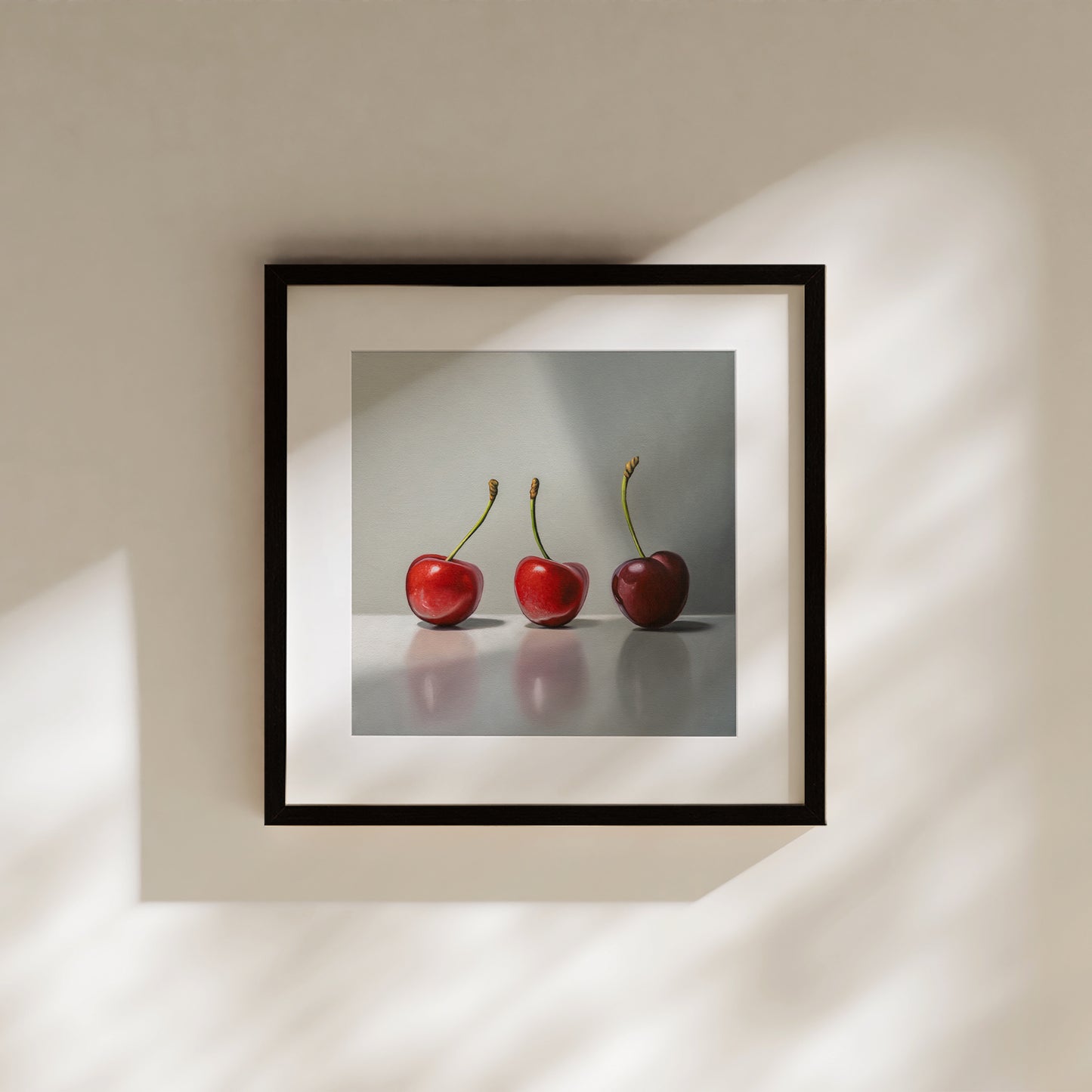 This painting features a trio of cherries in varied lighting on a reflective surface.