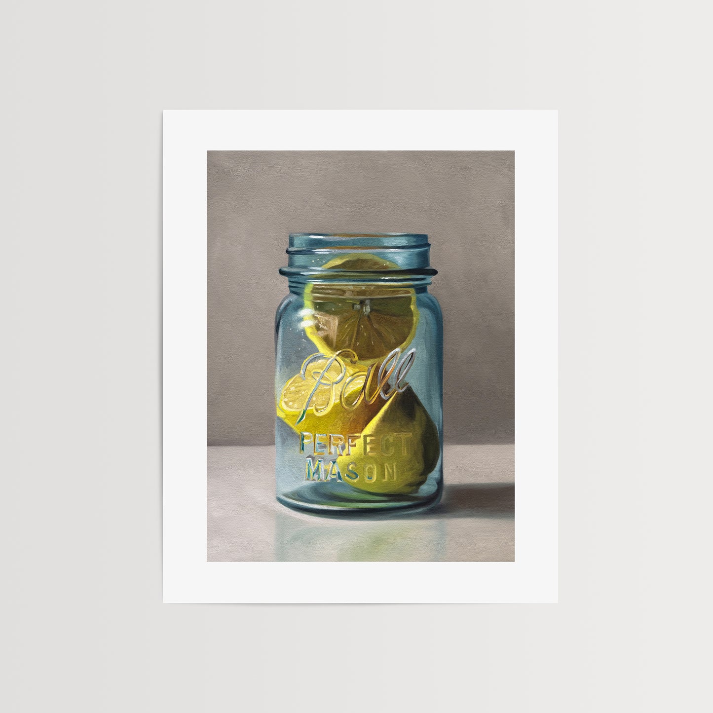 This artwork features a vintage turquoise jar containing a trio of lemon halves.