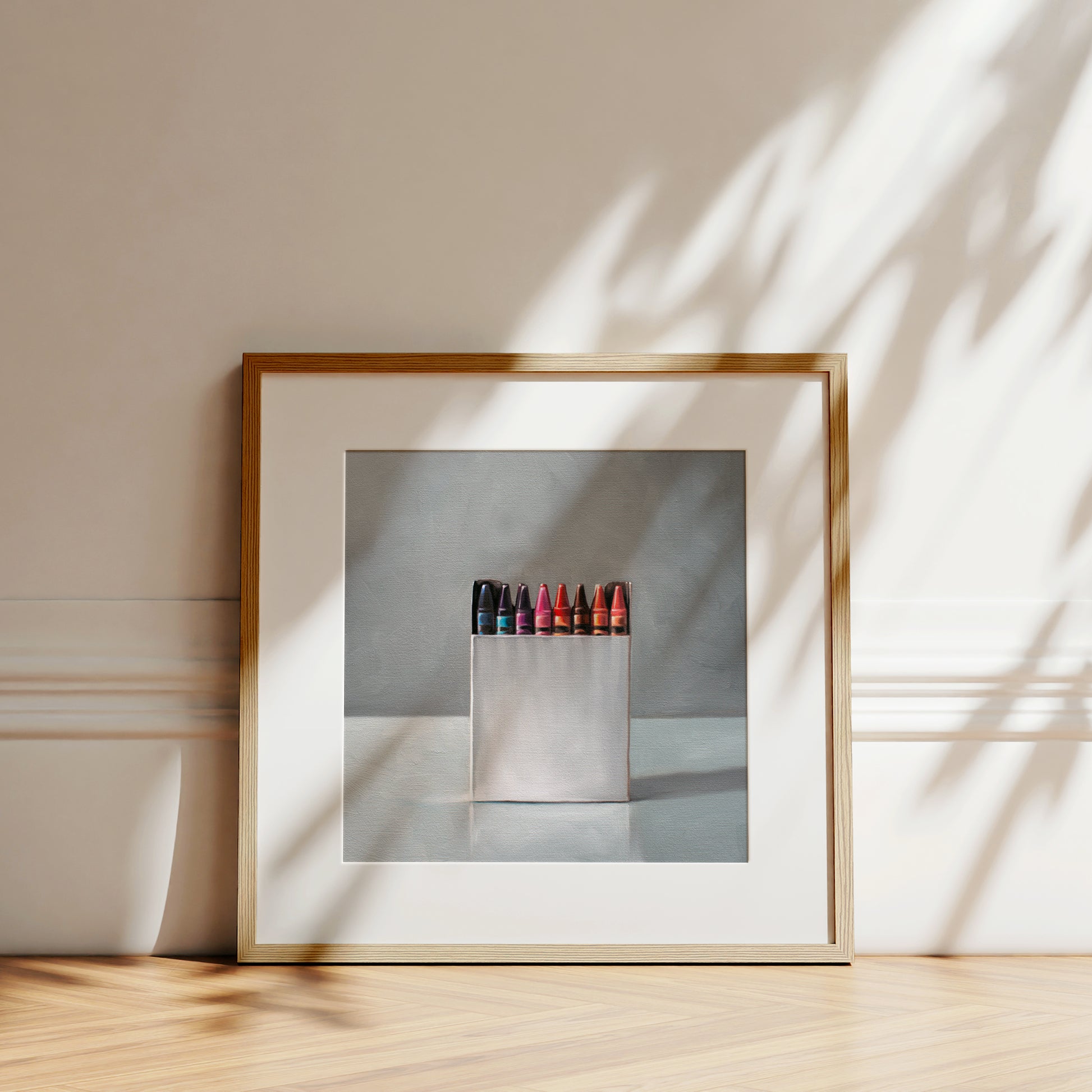 This artwork features a simple white box of crayons resting on a light reflective surface.