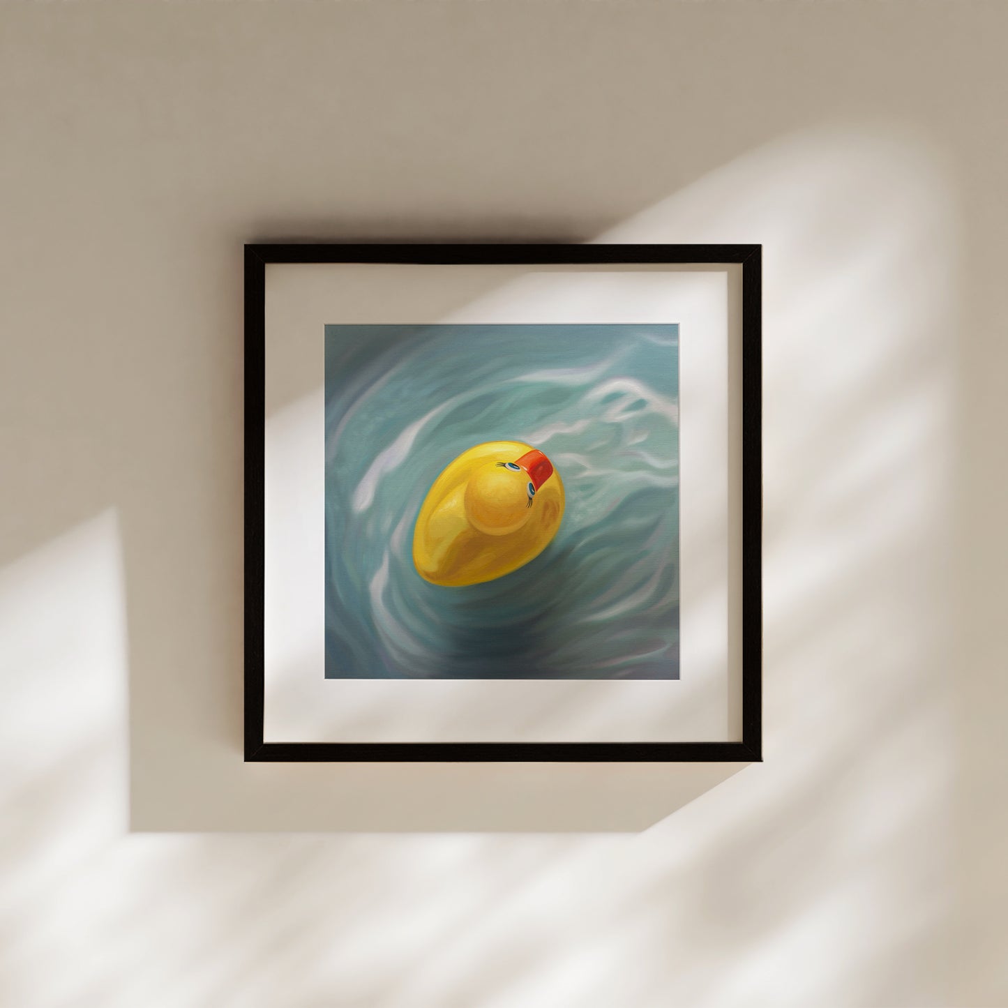 This artwork features a single rubber ducky floating in blue rippled water from above.