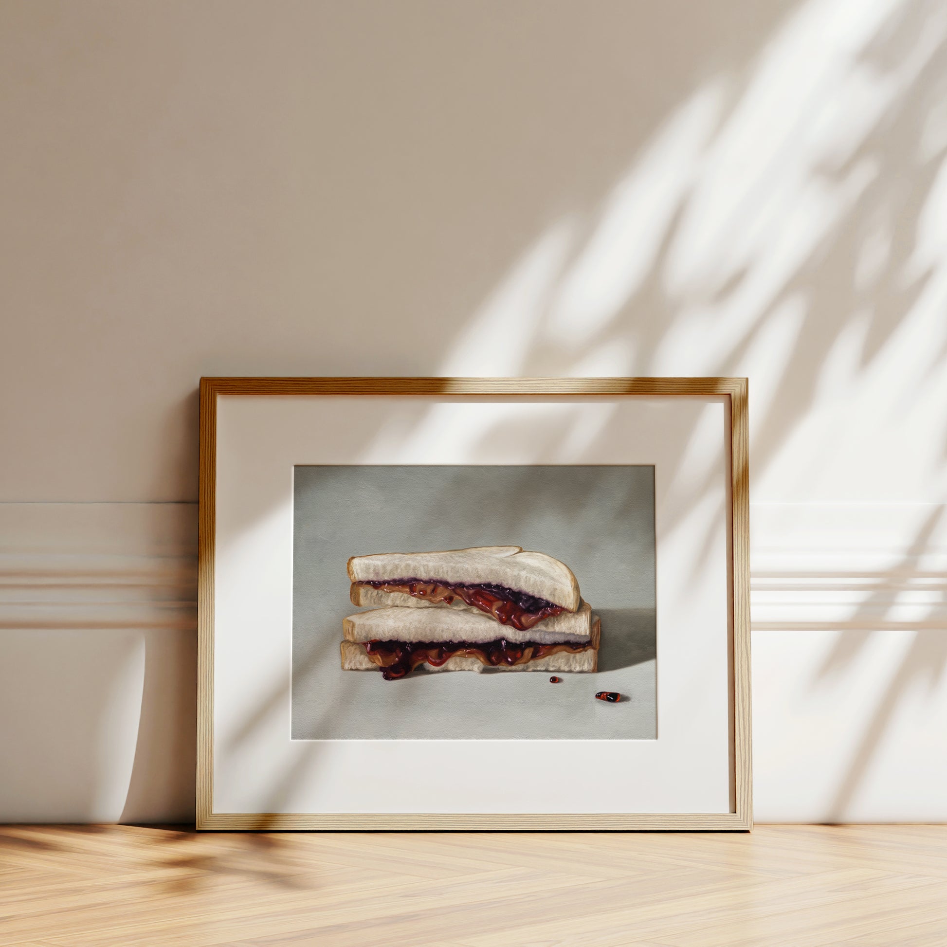 This artwork features a stacked peanut butter and jelly sandwich resting on a neutral grey surface.