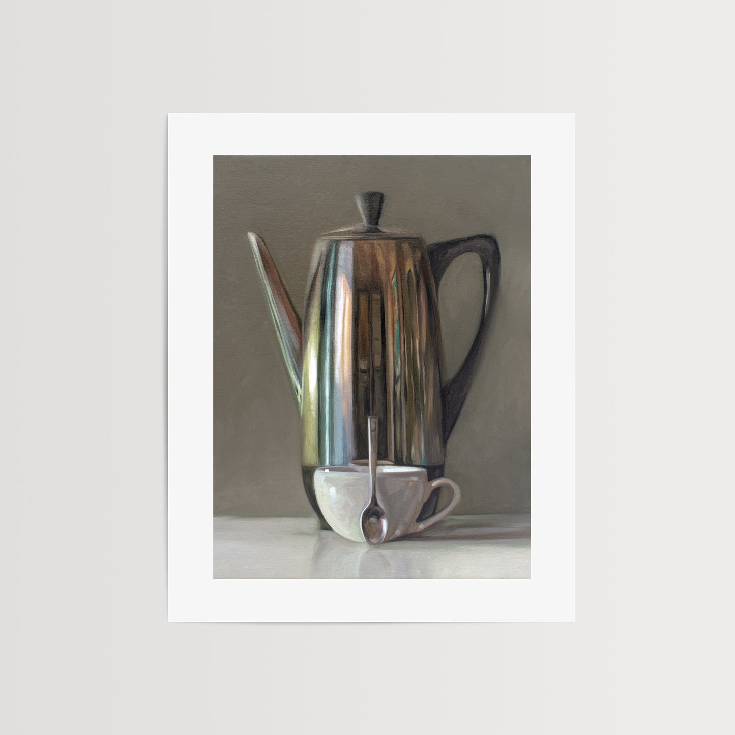 This artwork features a reflective percolator, porcelain coffee cup and small spoon resting on a light reflective surface with neutral grey tones.