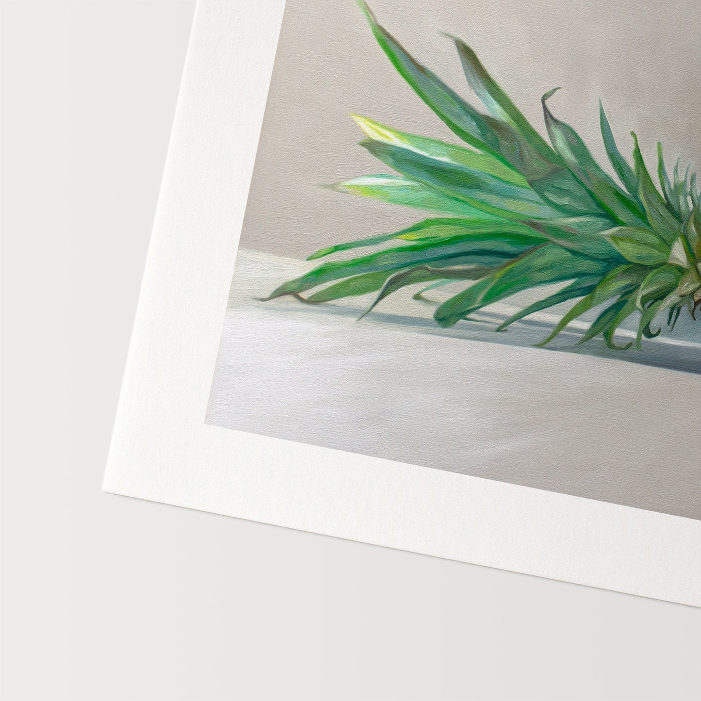 This artwork features a sideways resting pineapple with a blue tropical drink umbrella on top.