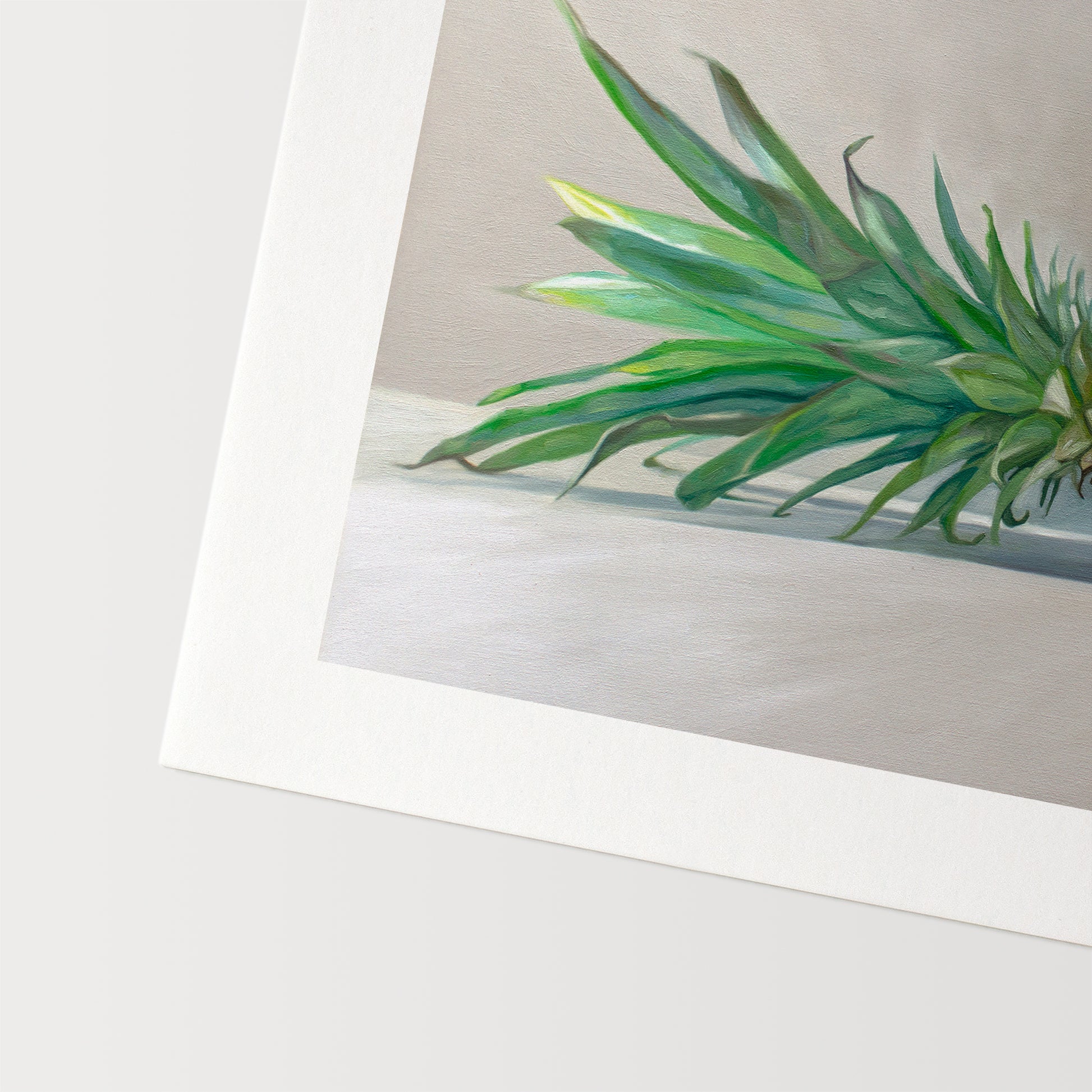 This artwork features a sideways resting pineapple with a blue tropical drink umbrella on top.