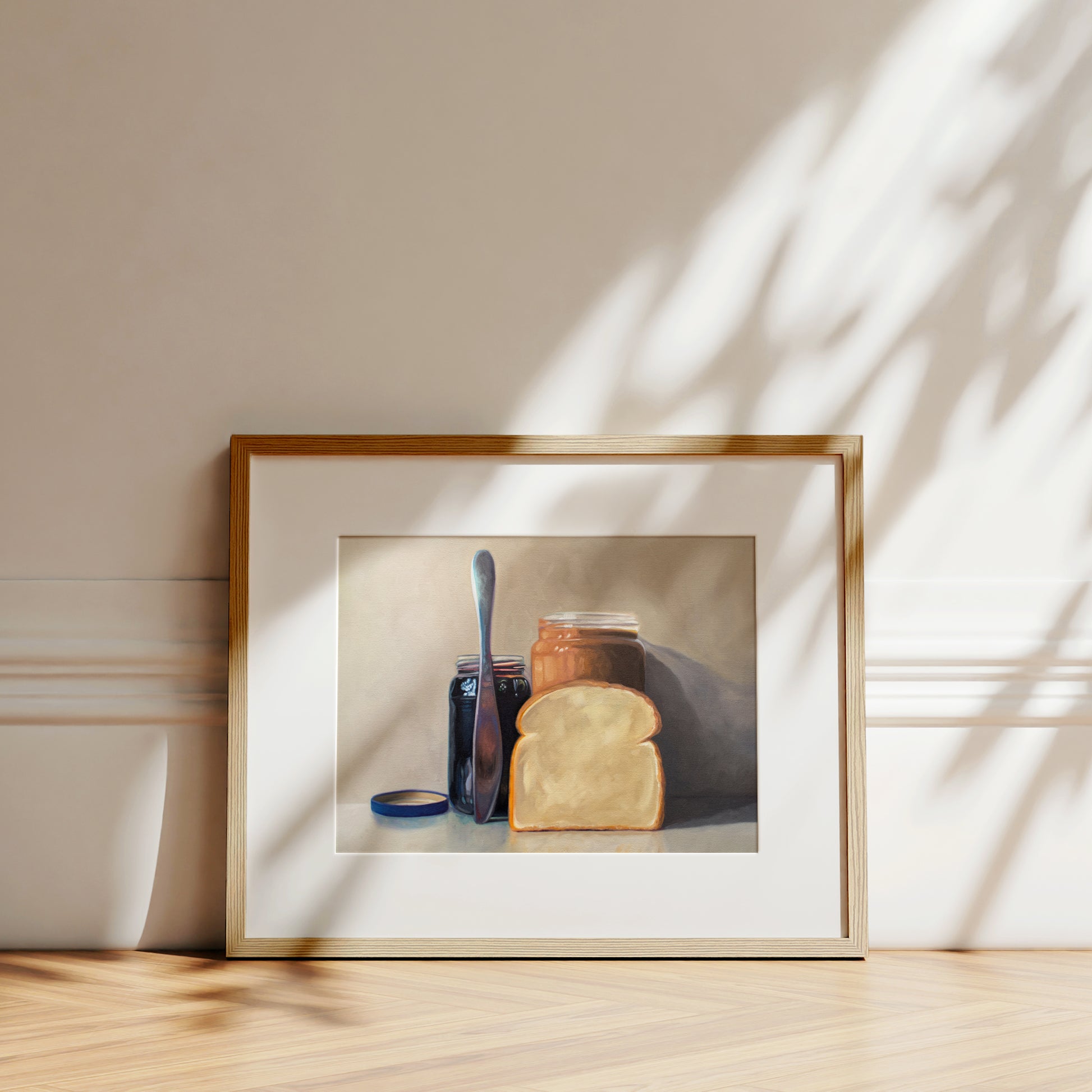 This artwork features all the things required to make a peanut butter and jelly sandwich lined up and ready to go on a light and neutral backdrop with subtle reflections.