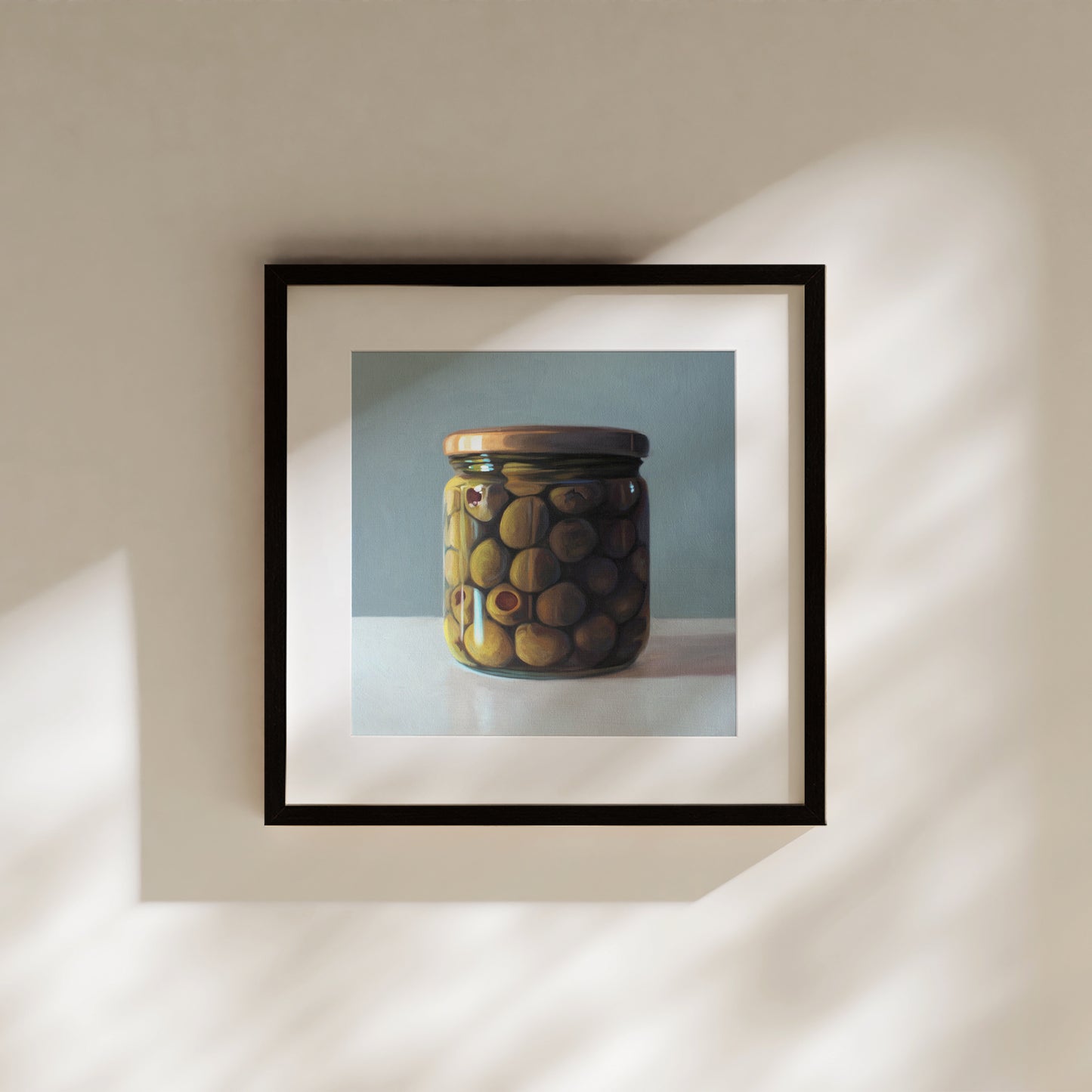 This artwork features a jar of green olives resting on a light, reflective surface with a muted blue/green background.