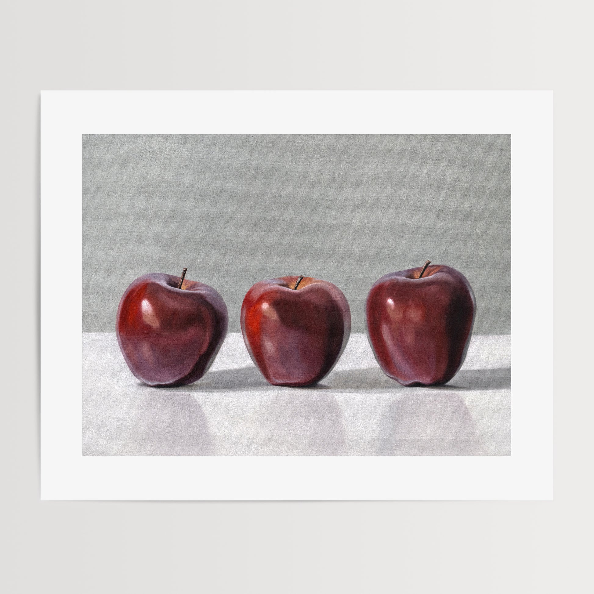 This artwork features a trio of Red Delicious apples resting on a light surface with a neutral grey background.
