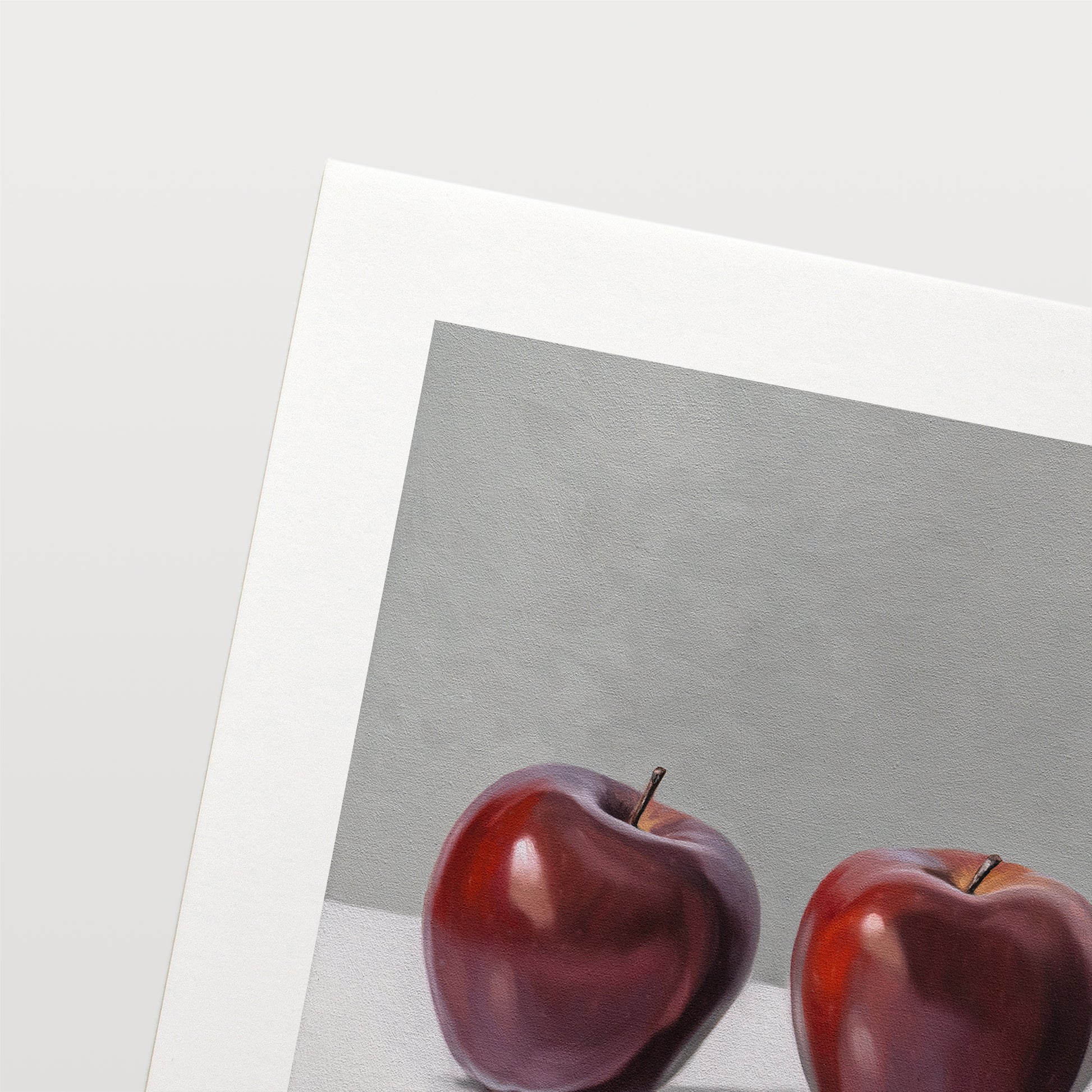 This artwork features a trio of Red Delicious apples resting on a light surface with a neutral grey background.