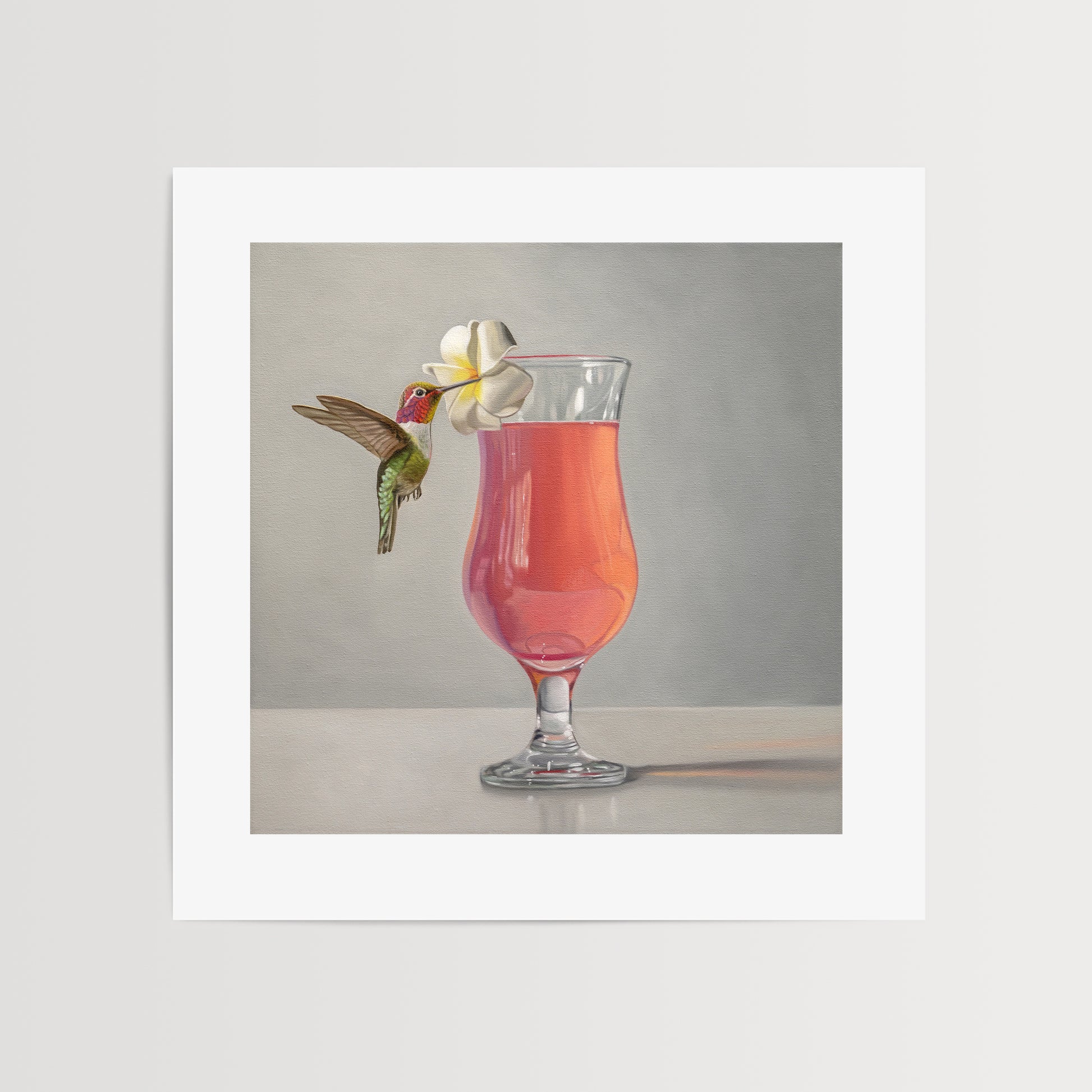 This artwork features an Anna’s Hummingbird visiting a plumeria blossom that rests on the lip of a pink cocktail.