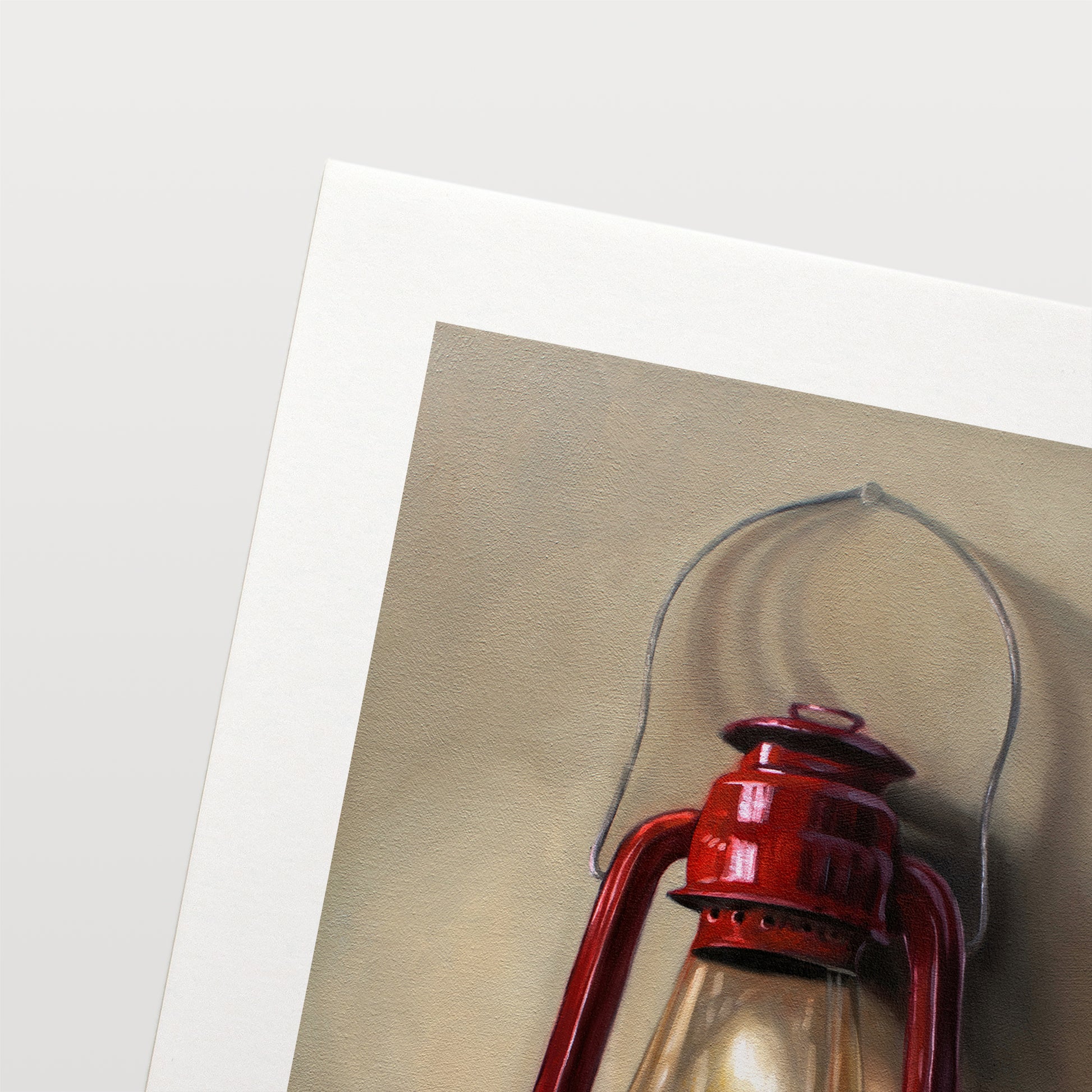 A vintage red lantern hangs from a single nail and casts a variety of interesting light and shadows upon the wall.