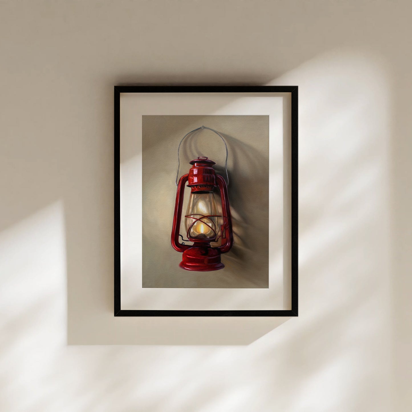 A vintage red lantern hangs from a single nail and casts a variety of interesting light and shadows upon the wall.
