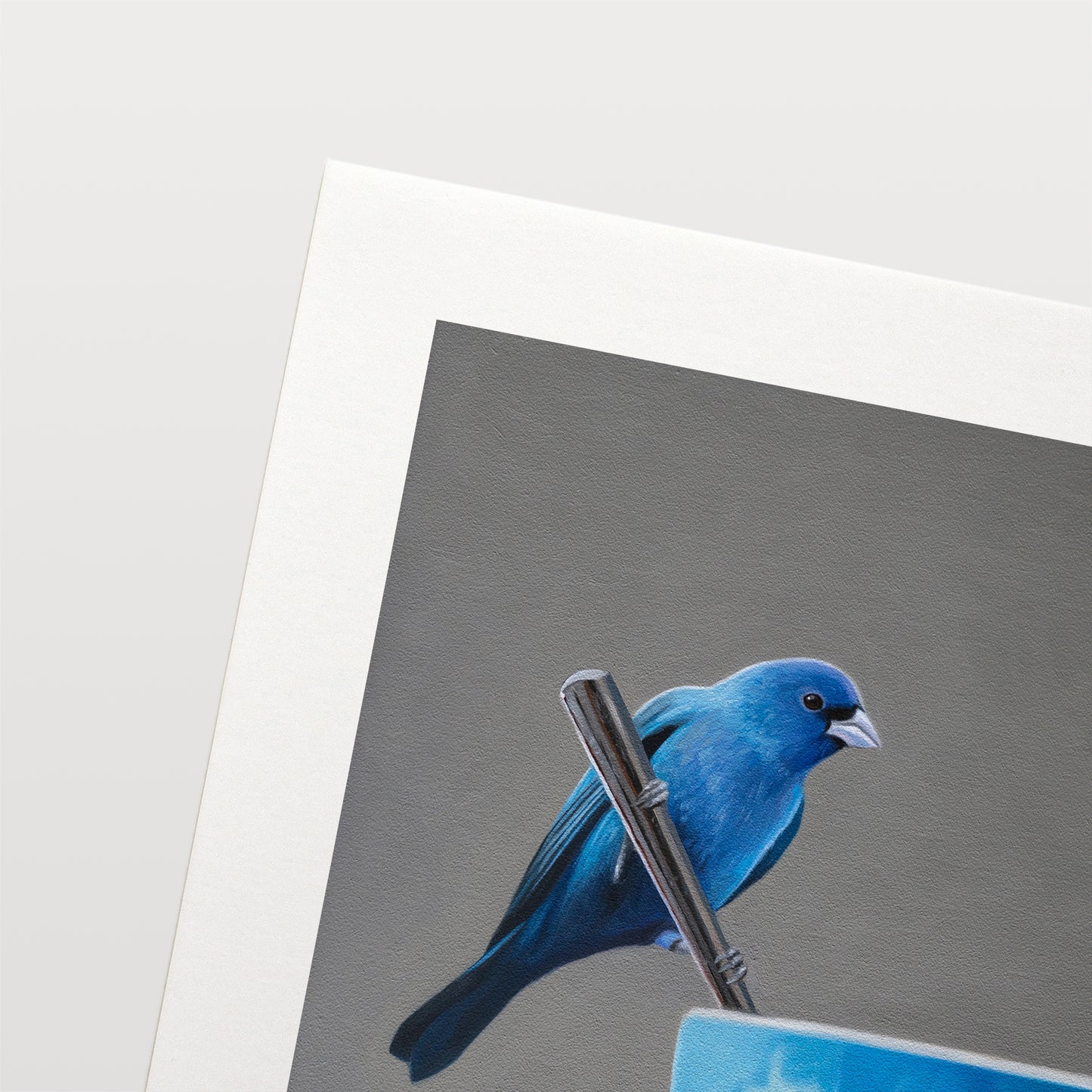 This artwork features an Indigo Bunting perched on the handle of a spoon resting on the edge of a blue cup with saucer.