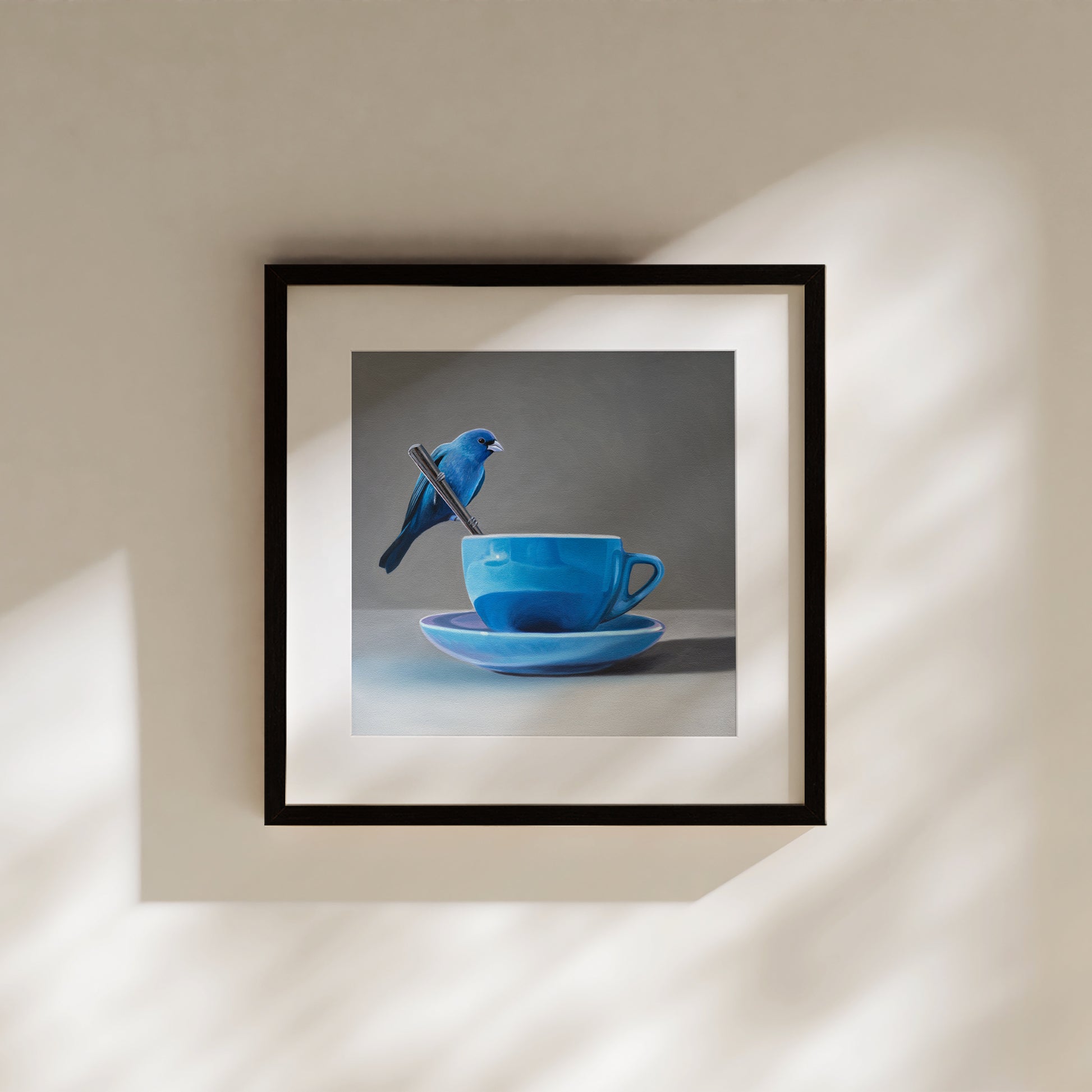 This artwork features an Indigo Bunting perched on the handle of a spoon resting on the edge of a blue cup with saucer.