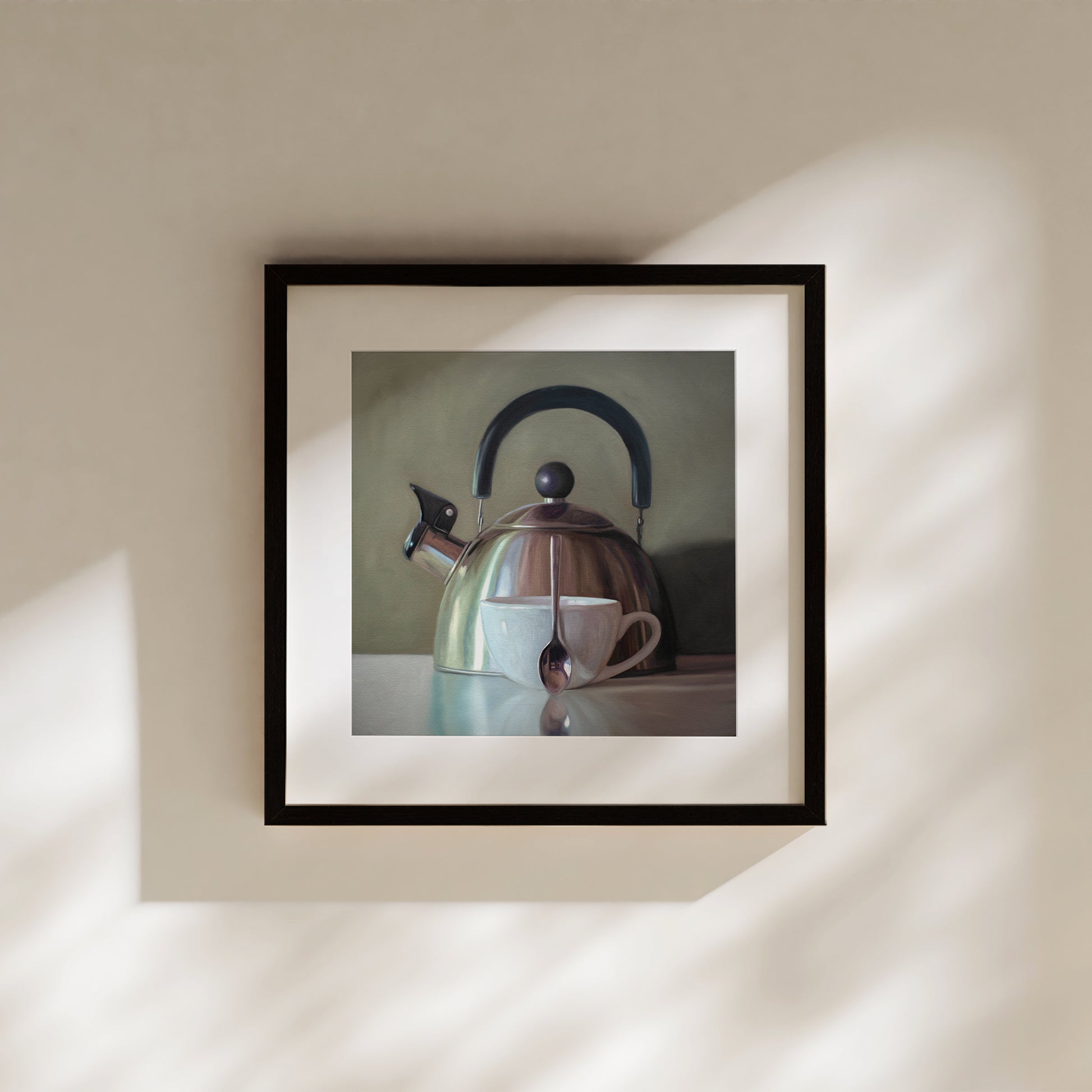This artwork features a coffee cup resting next to a vintage tea kettle.This artwork is from a series featuring tea kettles paired with various objects.