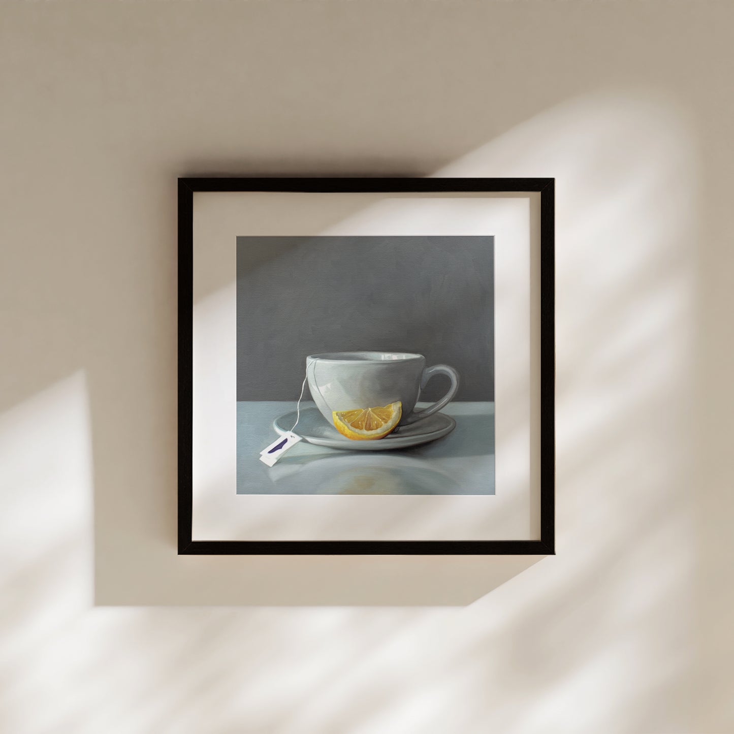 This artwork features a porcelain cup and saucer with tea and a lemon wedge.