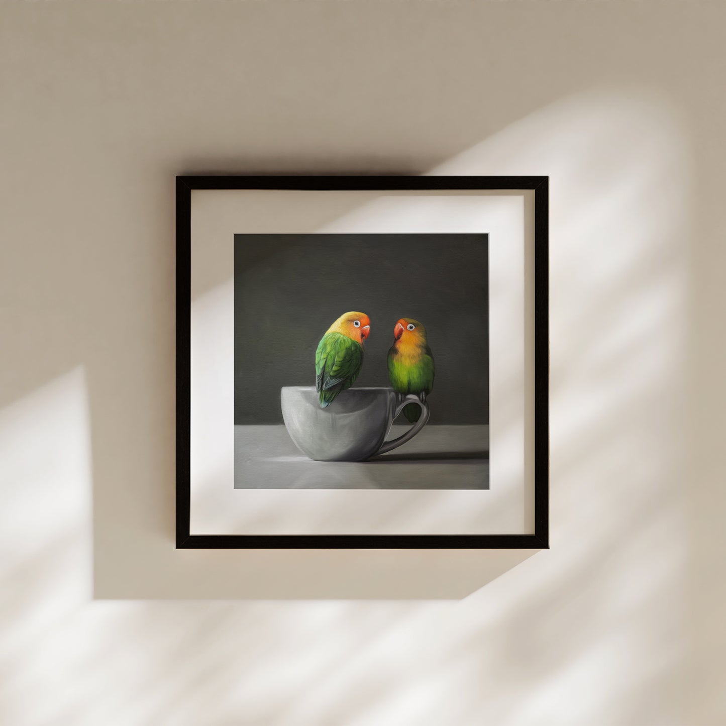 This artwork features a pair of Fischer’s Lovebirds perched on a white porcelain cup.