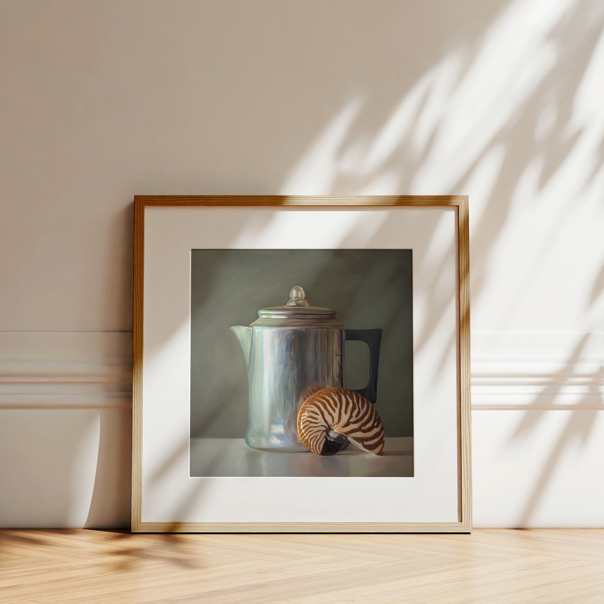 This artwork features a nautilus shell resting next to a vintage tea kettle.This artwork is from a series featuring tea kettles paired with various objects.