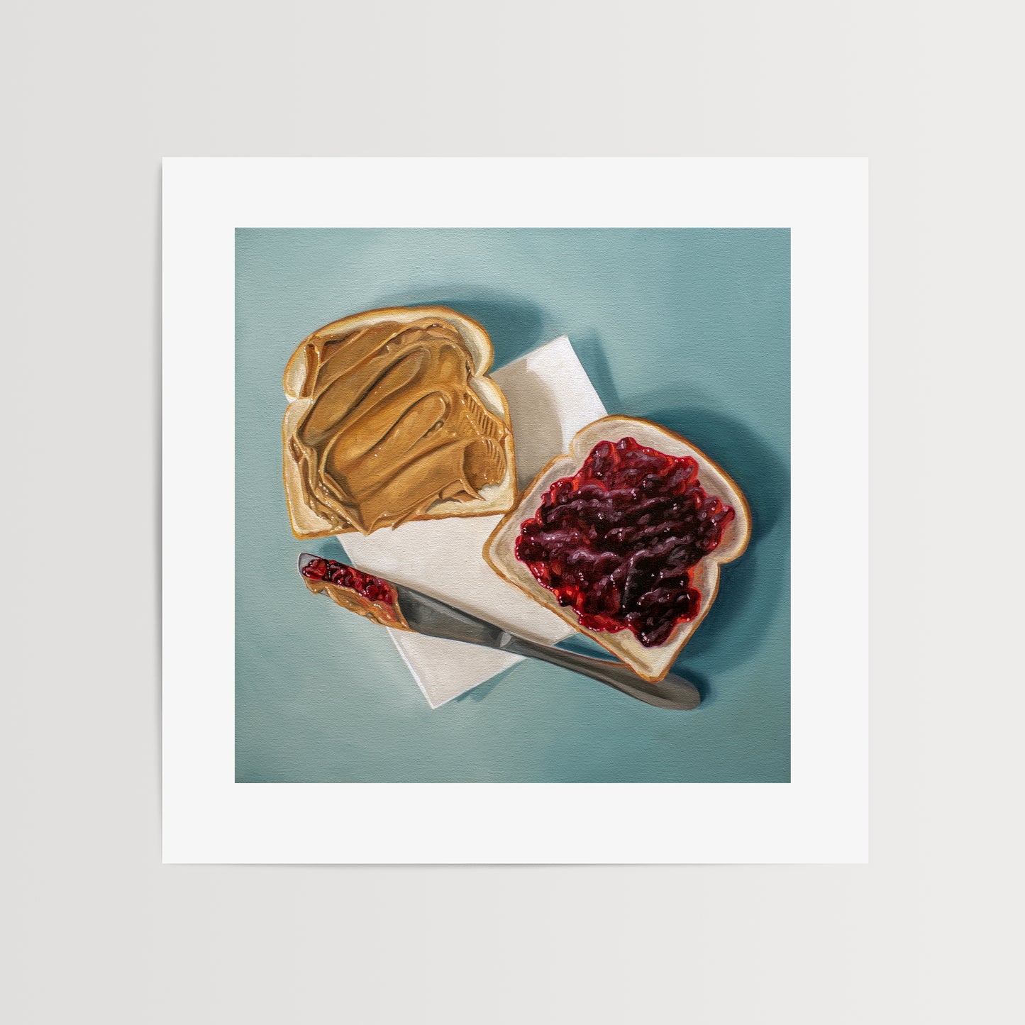 This artwork features a yet to be assembled peanut butter and jelly sandwich… the very moment just before you smoosh the two sides together.