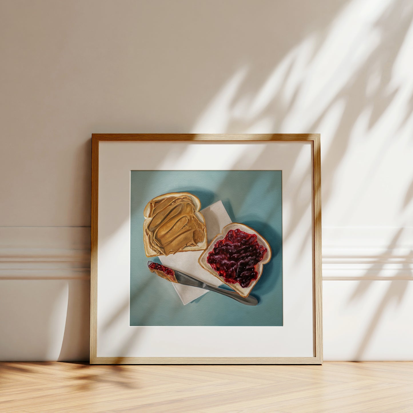 This artwork features a yet to be assembled peanut butter and jelly sandwich… the very moment just before you smoosh the two sides together.