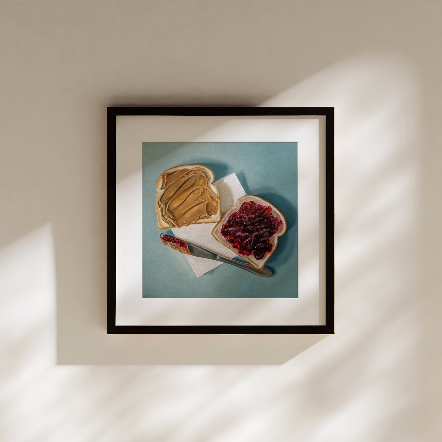 This artwork features a yet to be assembled peanut butter and jelly sandwich… the very moment just before you smoosh the two sides together.